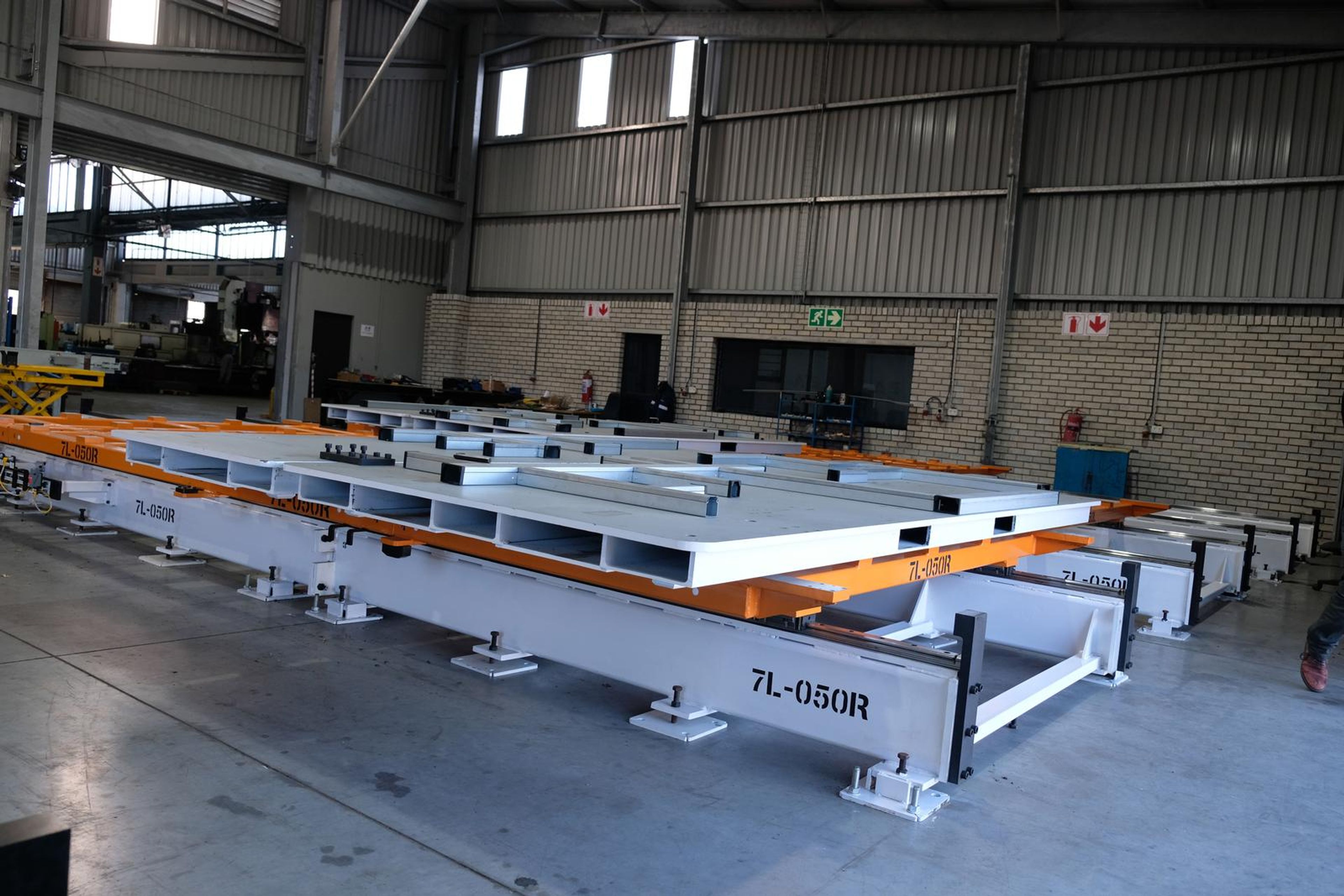 Wide view of the white steel tool stencilled 7L-050R in the plant