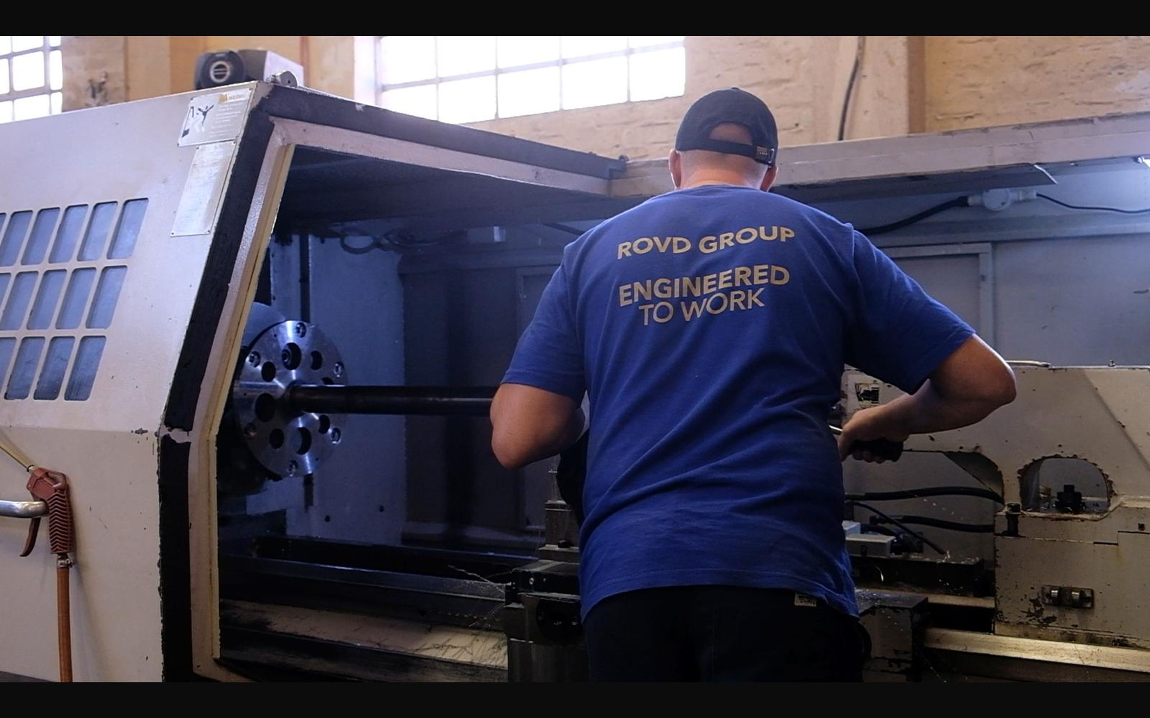 Machinist operating a large lathe
