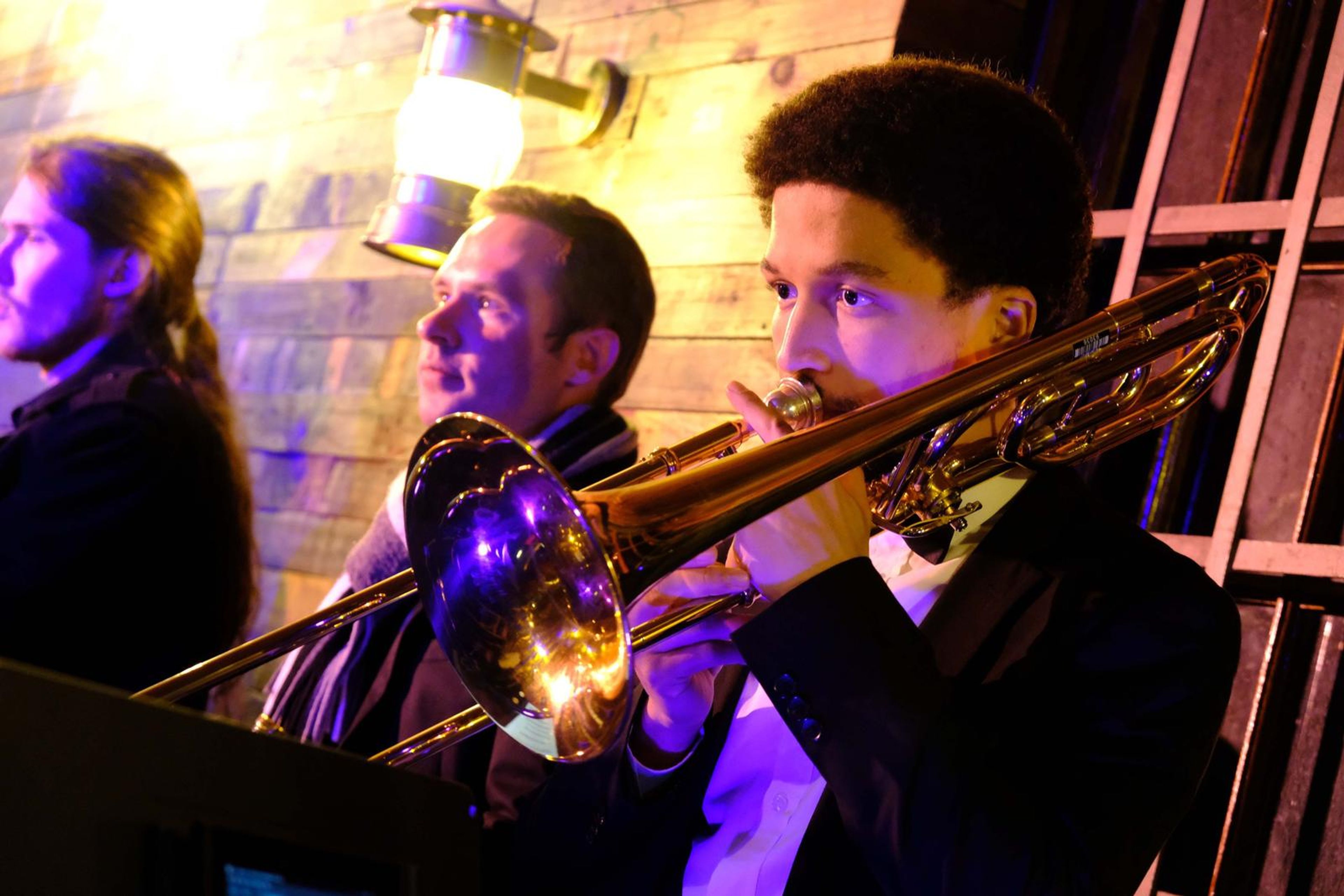 Trombonist and a band member sharing a laugh while playing