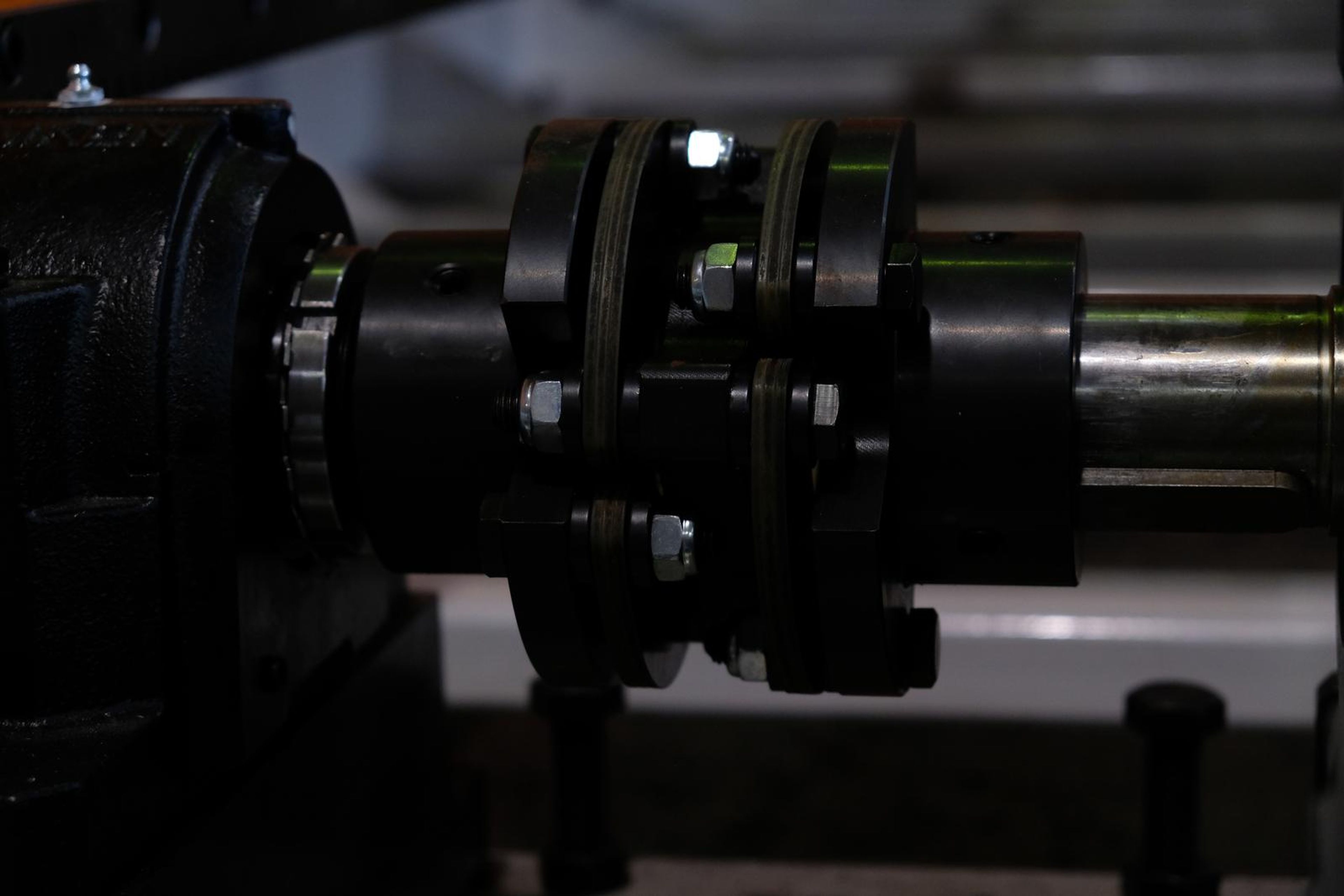 Black drive coupling and bearing housing on a steel shaft