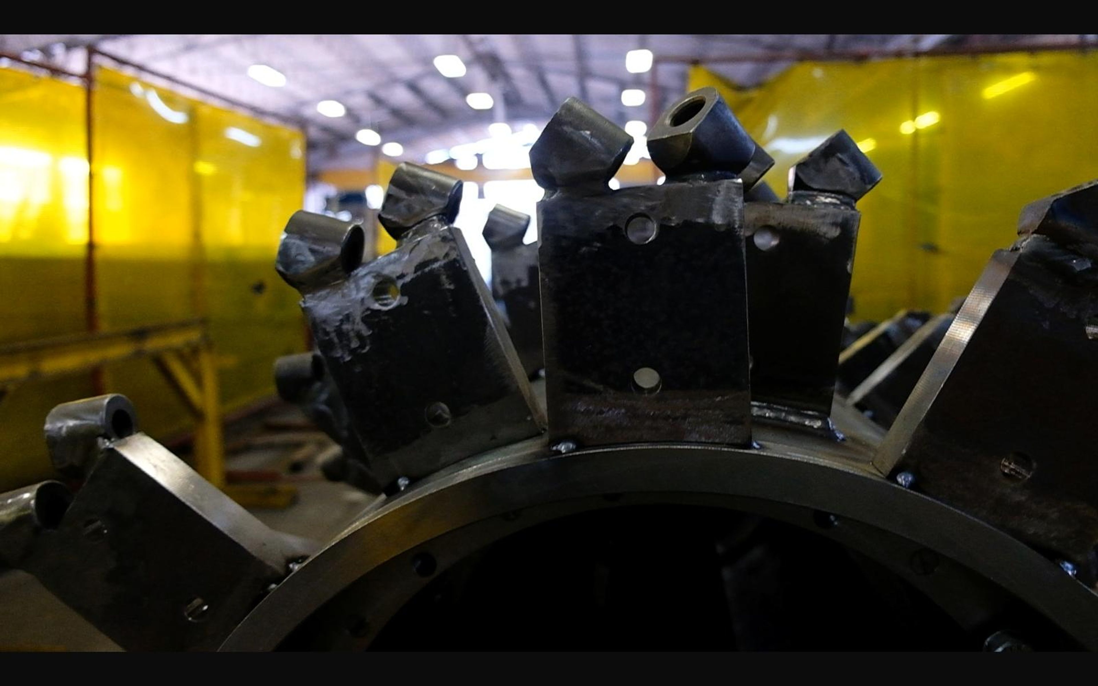 Steel mounting brackets arranged around a large drum