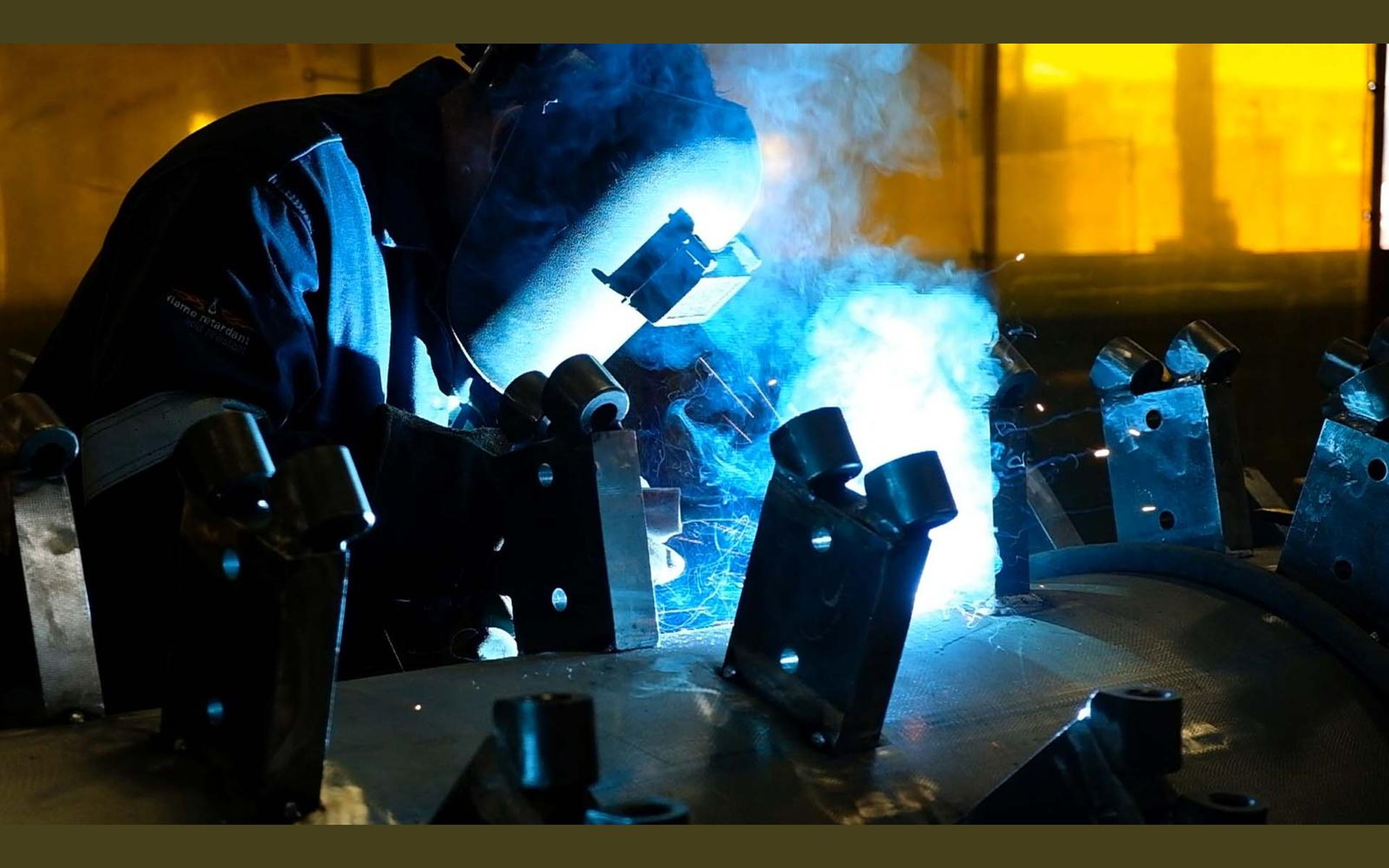 Steel mounting brackets in a yellow lit bay