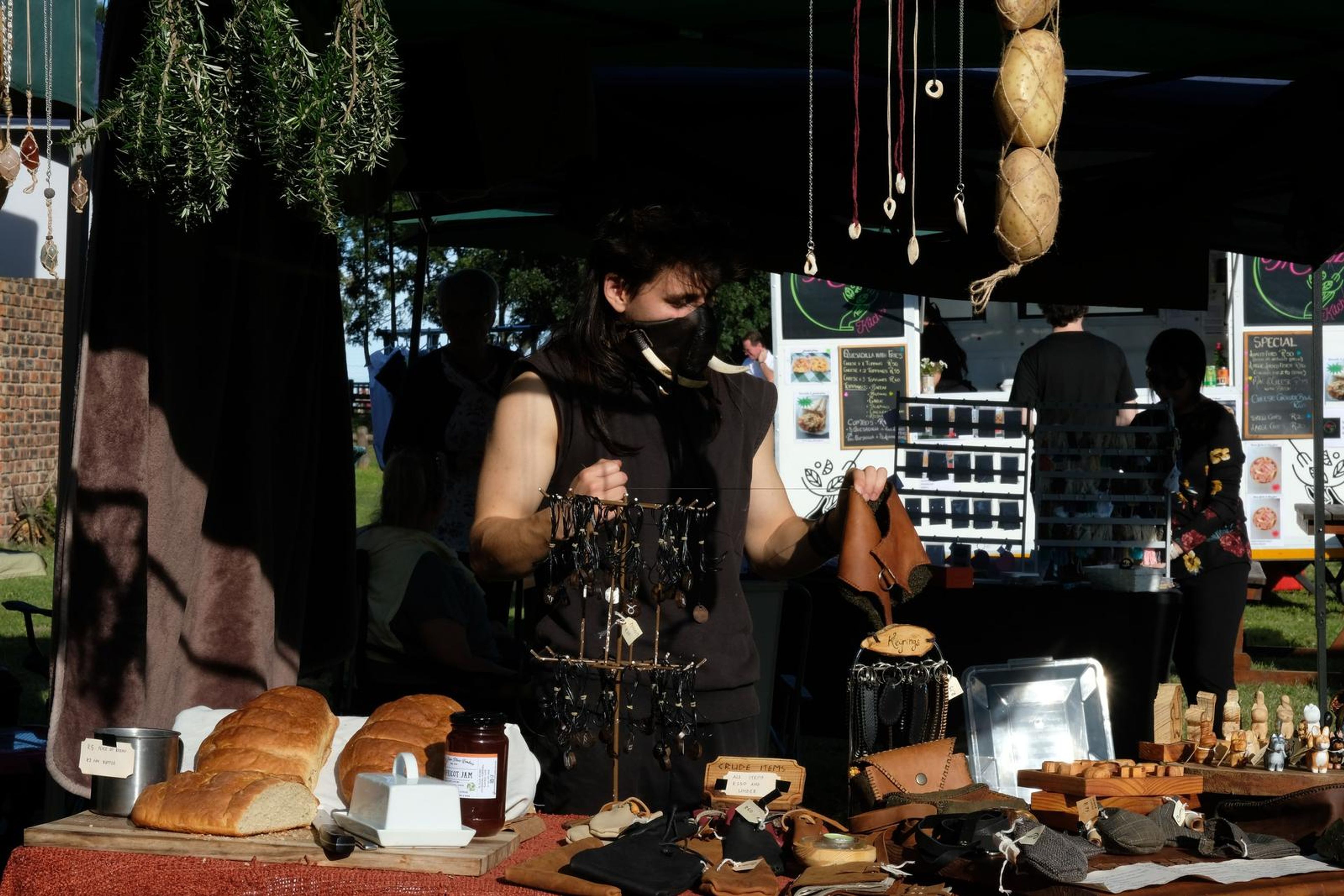 Juuks stall at Windsong Boho market with the maker working behind the display