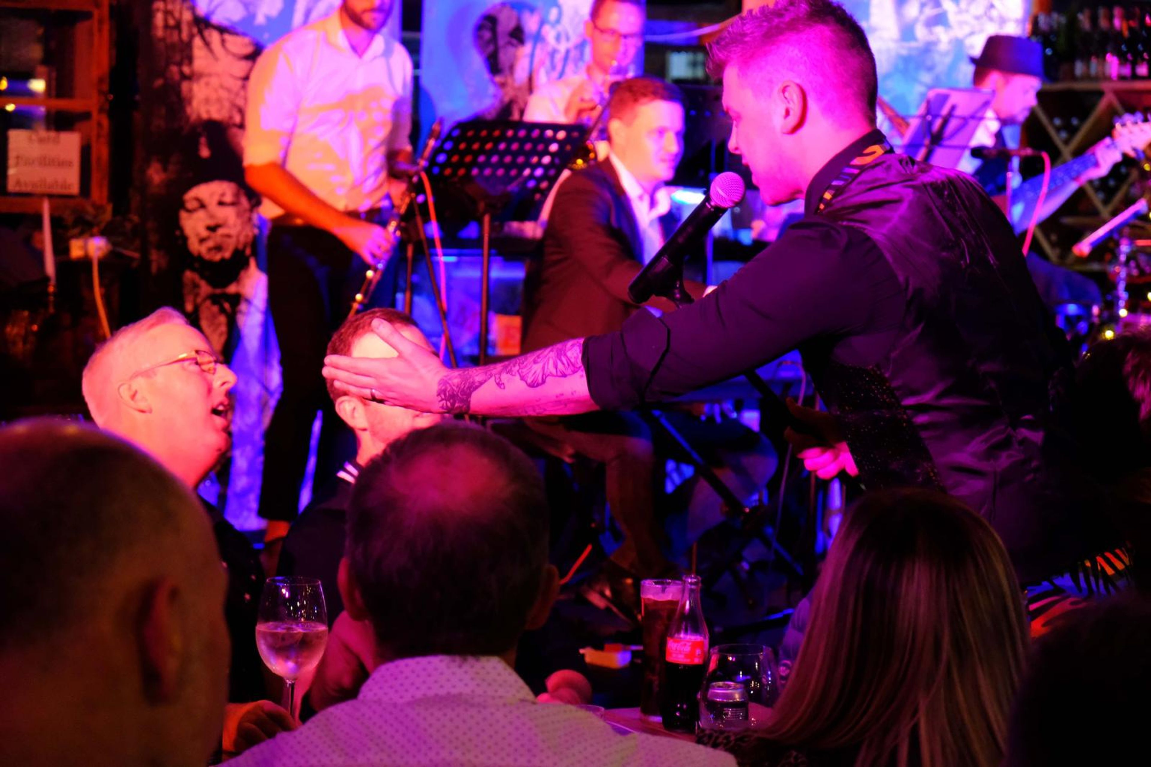 Singer reaching out to a guest while the band plays