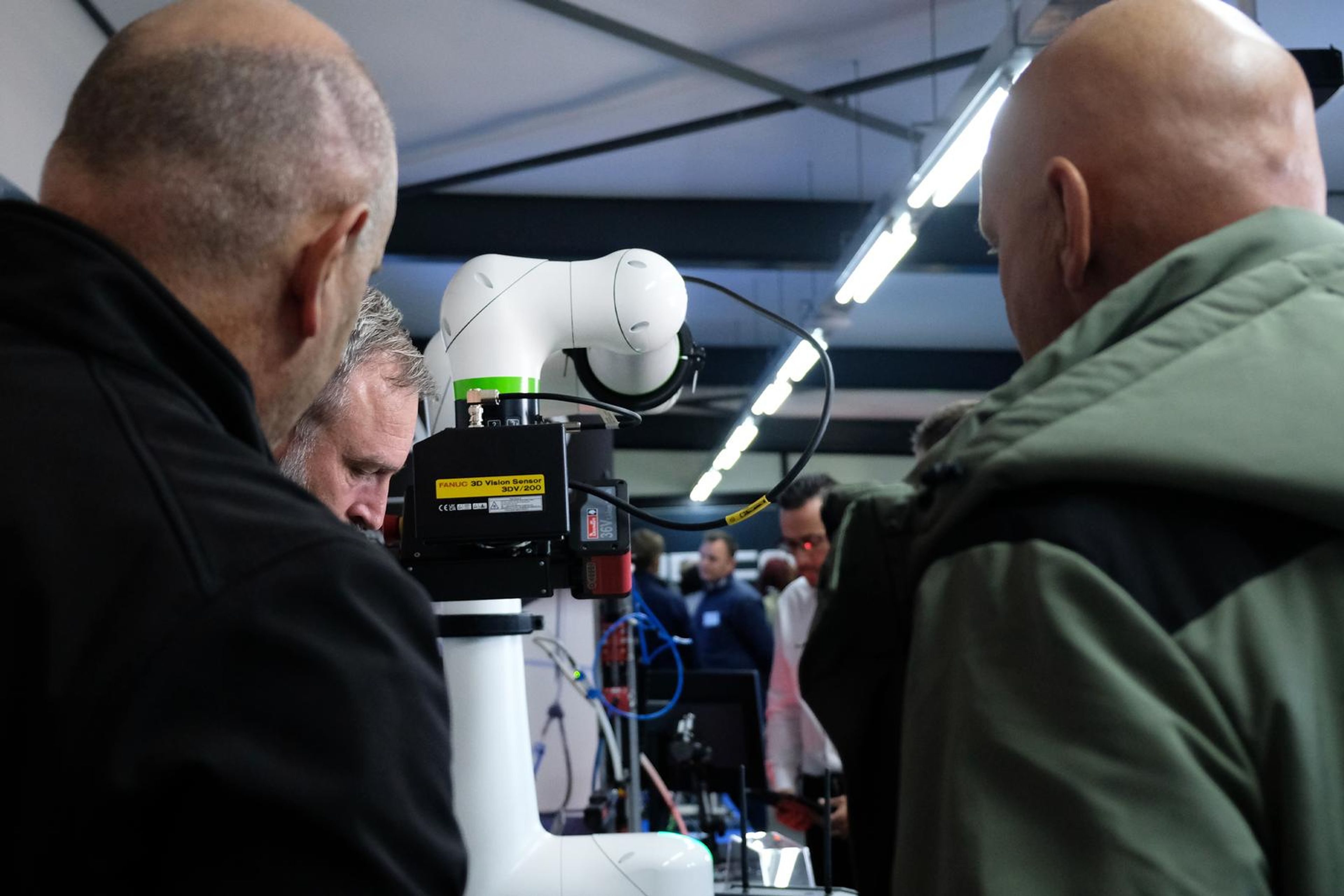 Visitors looking at a Fanuc collaborative robot