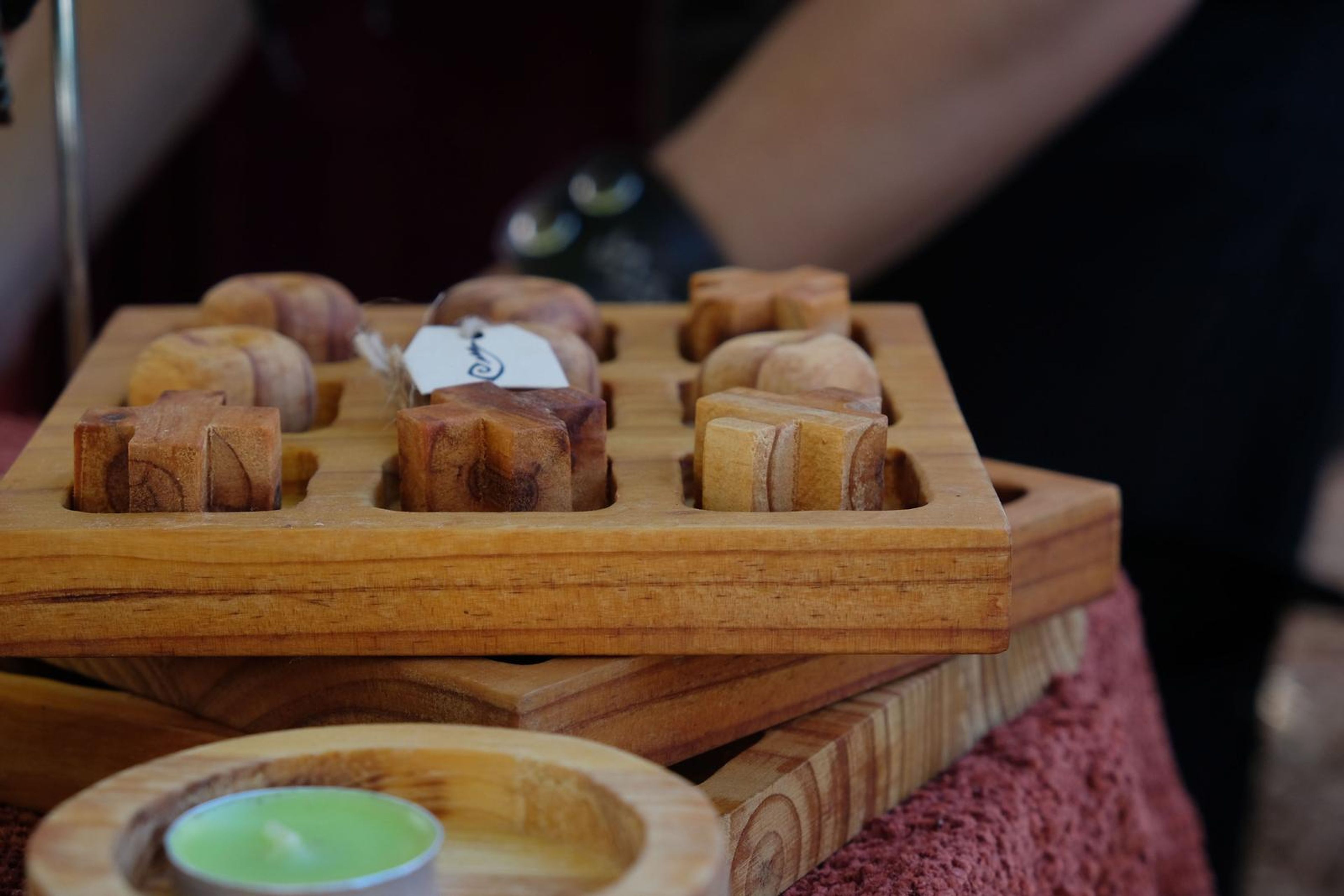 Hand-carved wooden candle holders and a wooden game at the Juuks stall