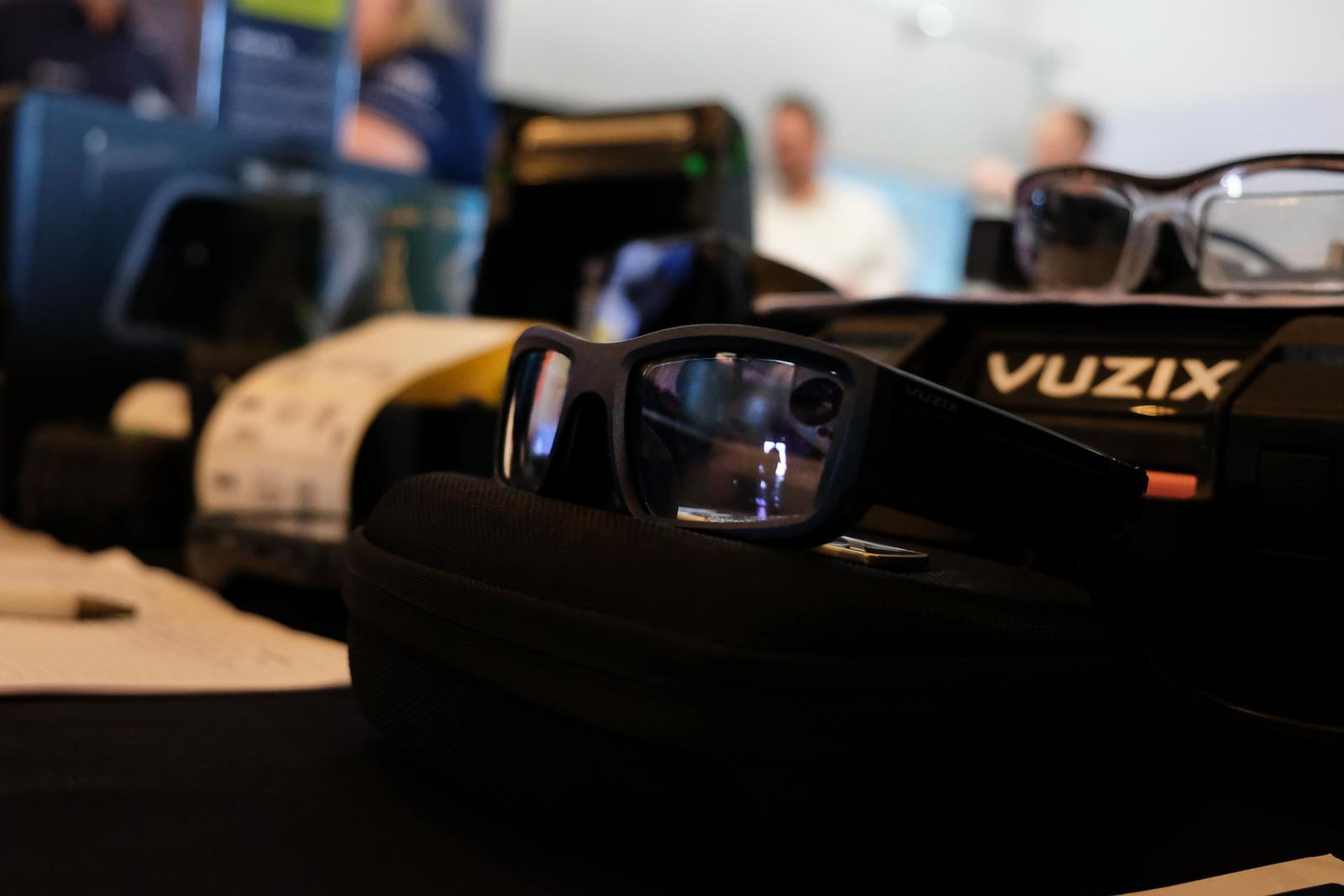 Vuzix smart glasses on the PDC stand with visitors behind