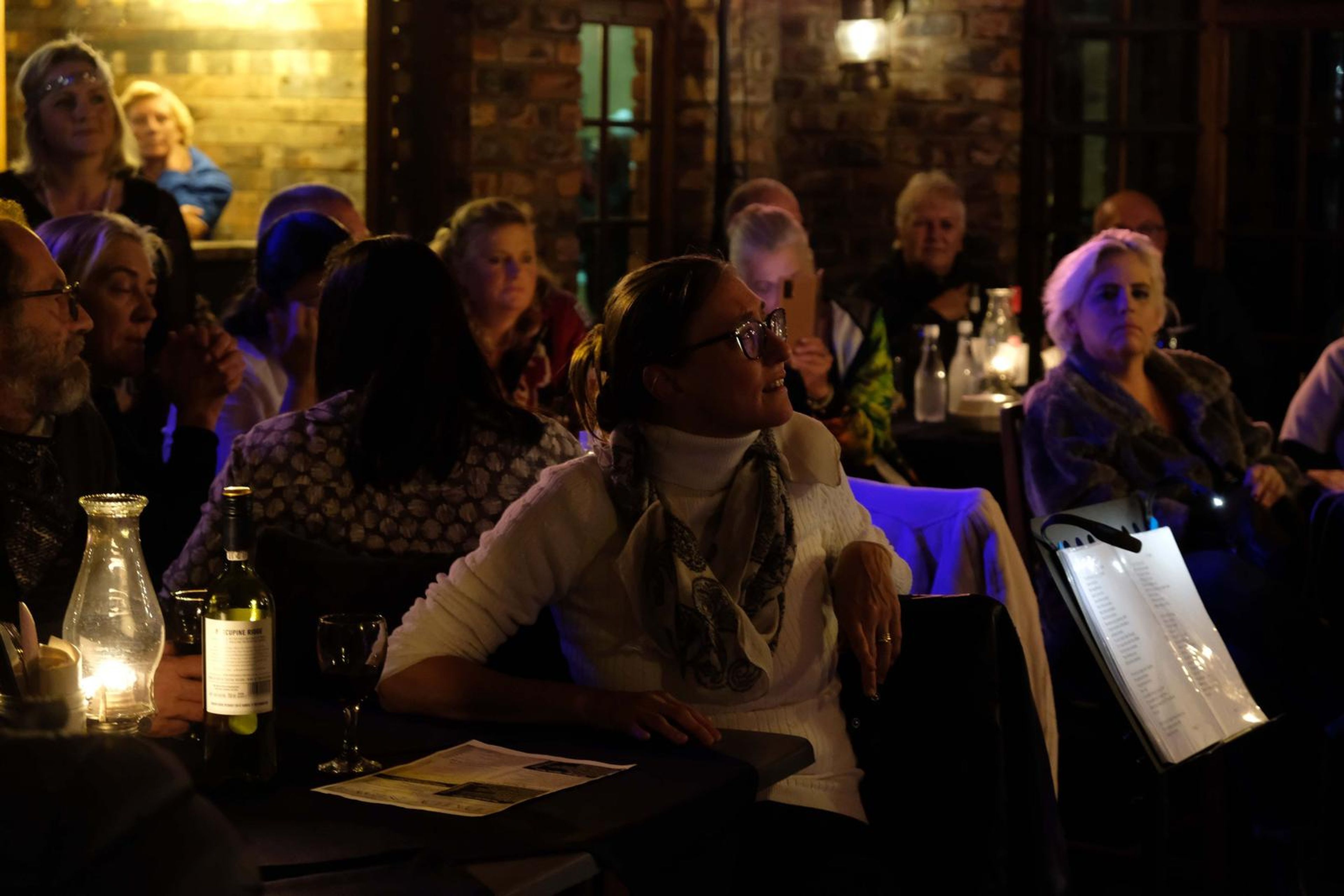 Diners at candle-lit tables listening to the band