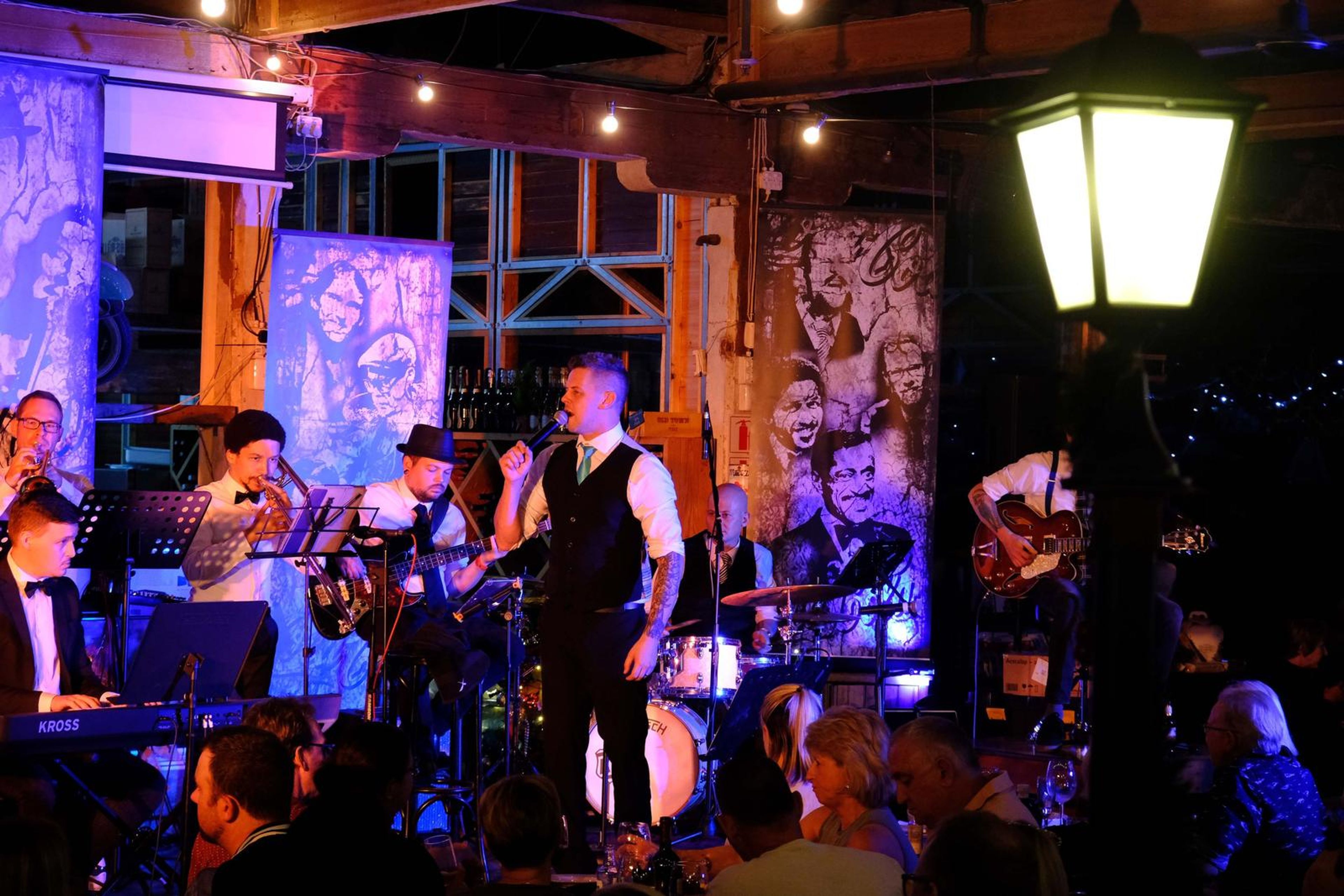 Band on stage framed by a street lantern