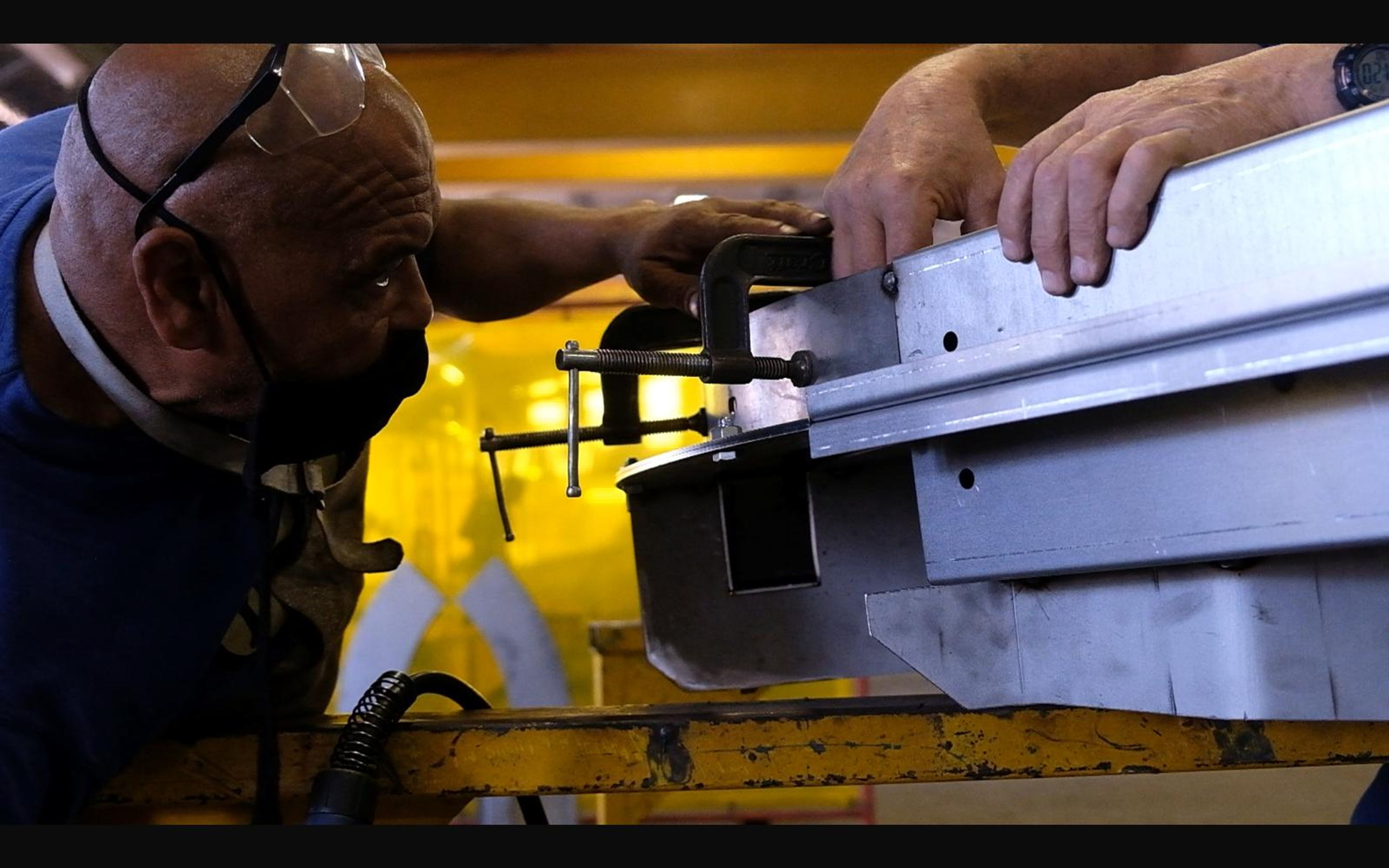 Workers clamping a steel box section