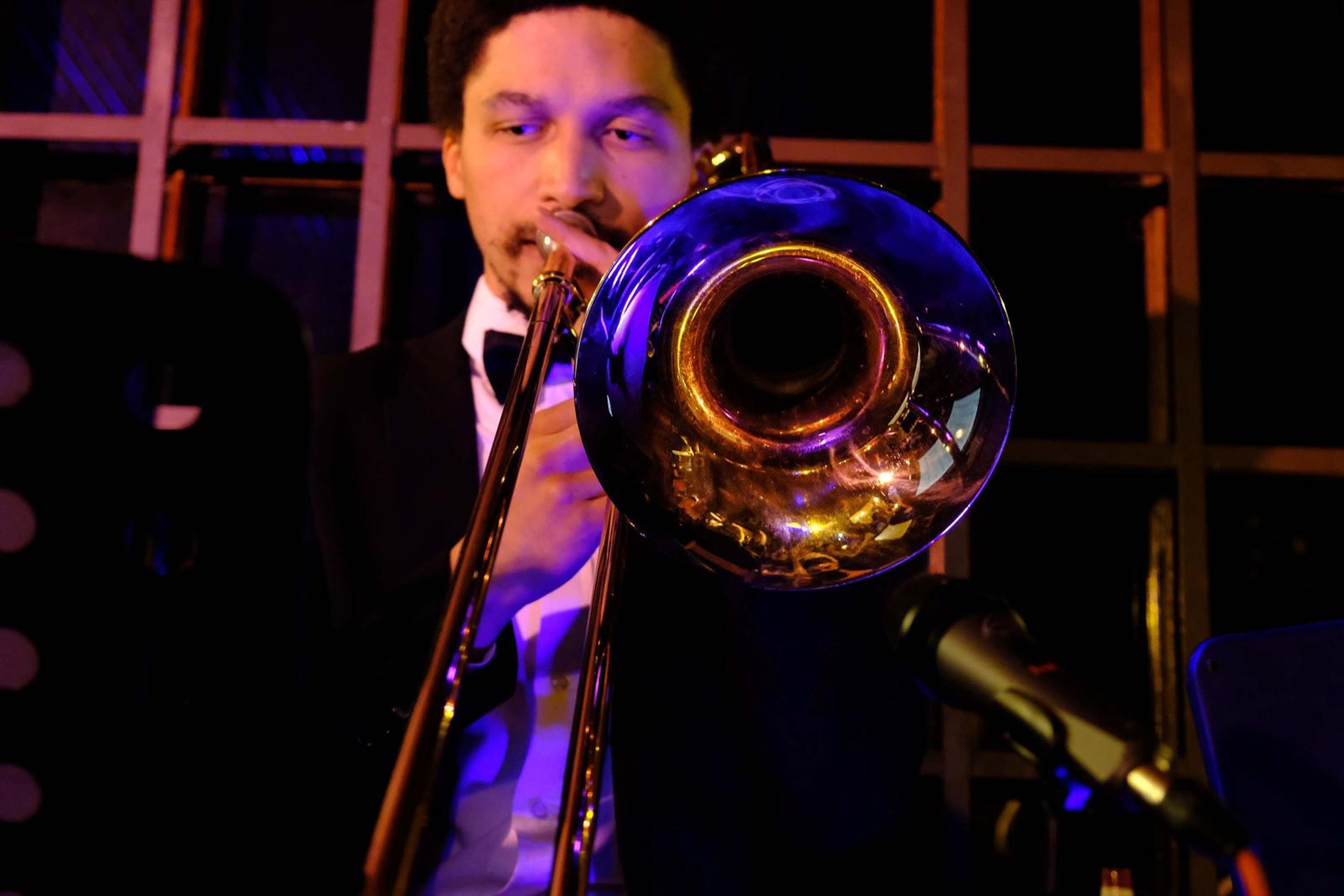 Close-up of the trombonist playing in warm light
