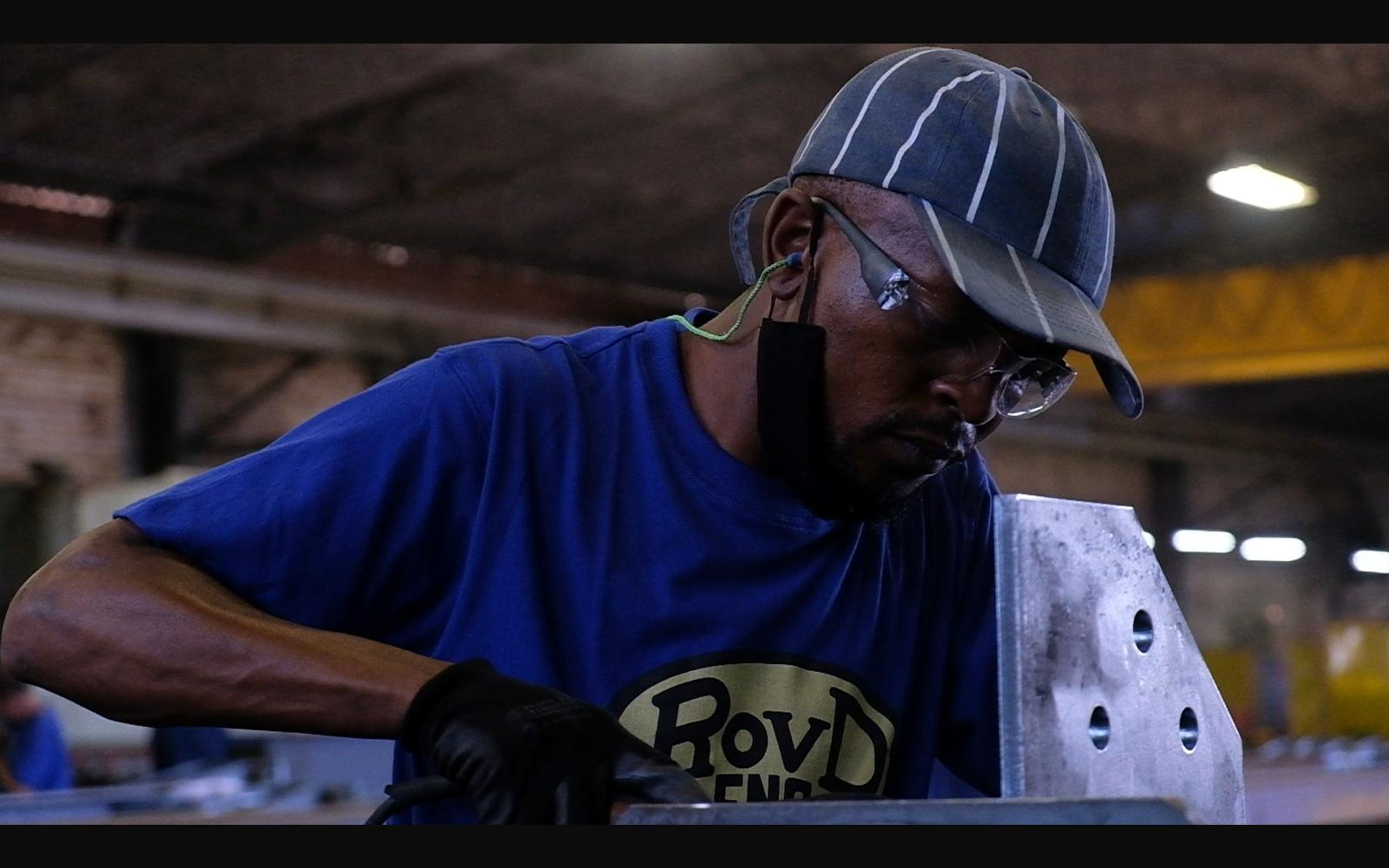 Fabricator in a cap and ROVD shirt at work