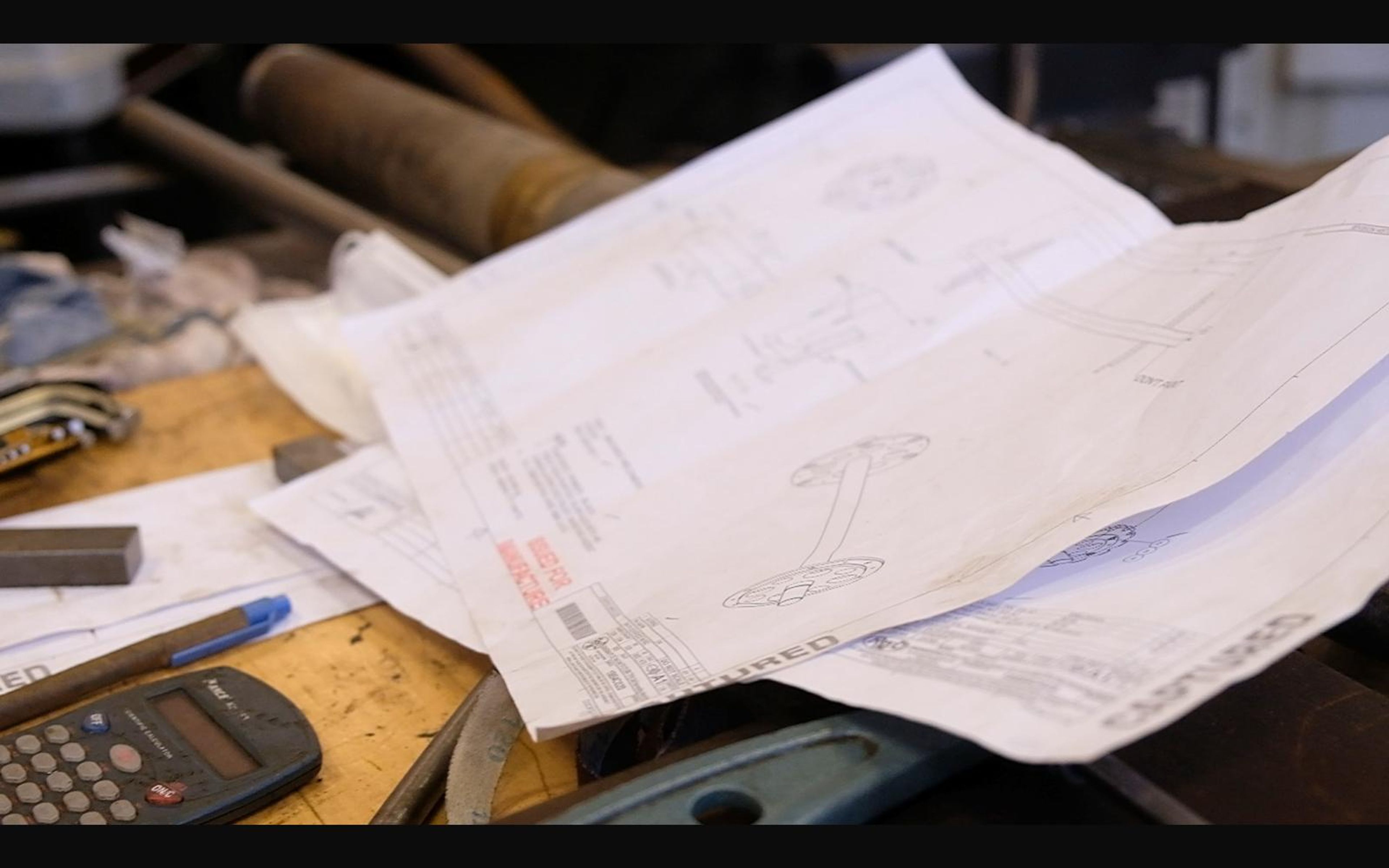 Engineering drawings on a workbench