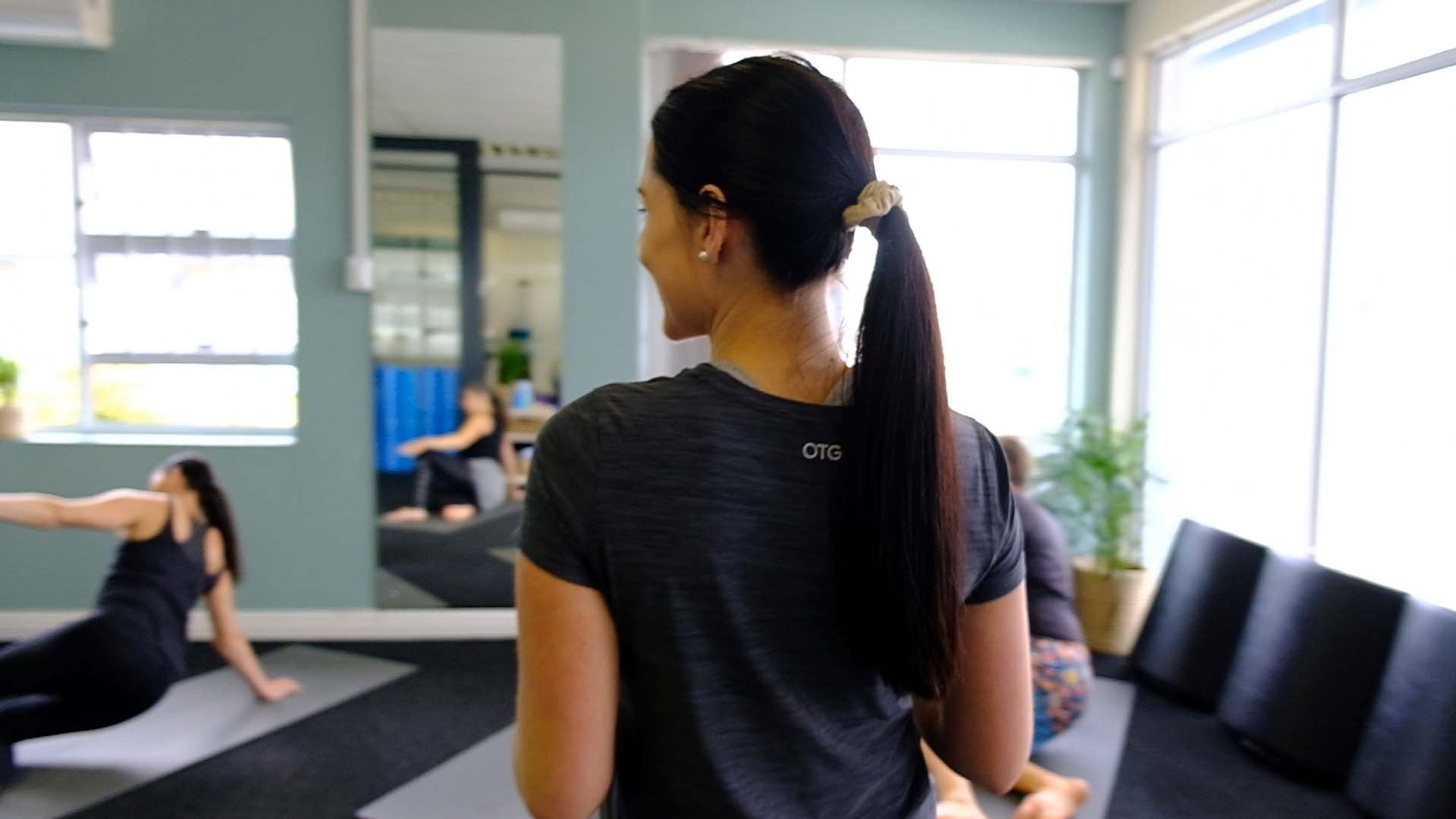 Staff member looking over her shoulder at a class in progress