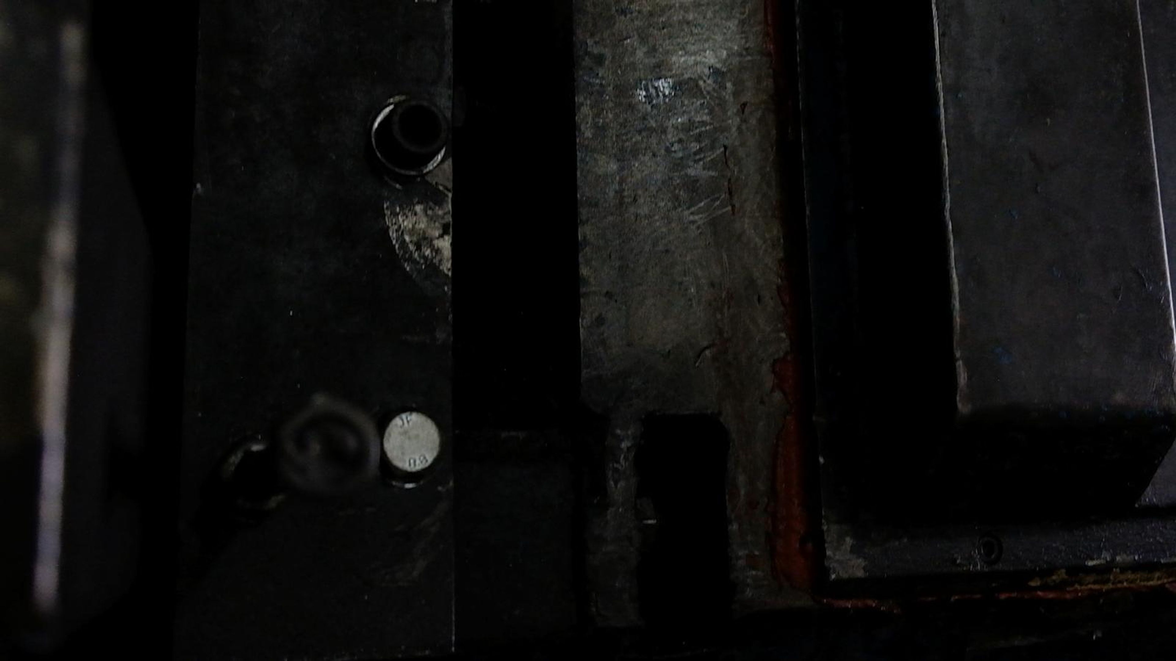 Dark machine fixture with a steel clamp block
