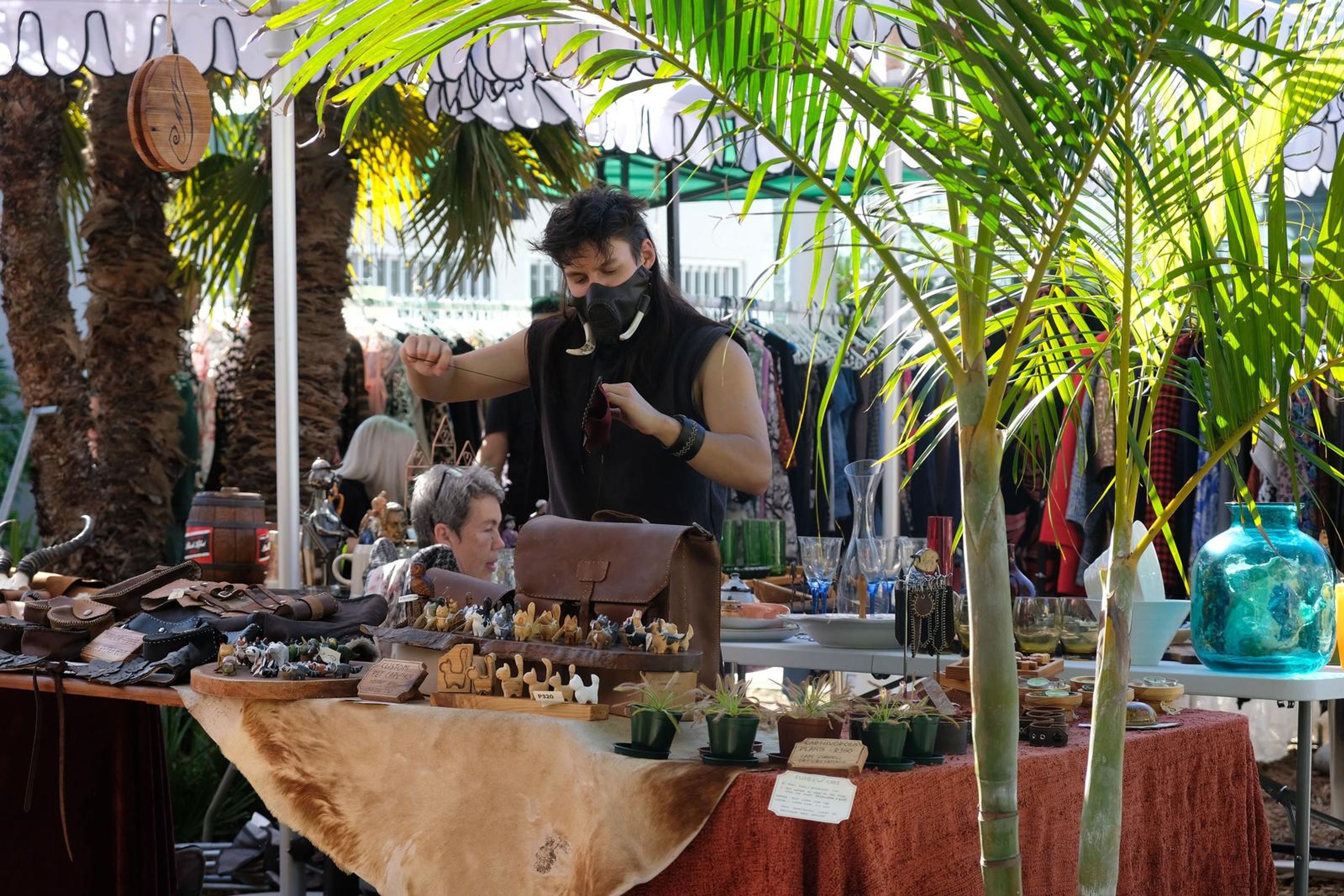 Juuks maker at the stall under the palm trees at Filthy McNasty's market