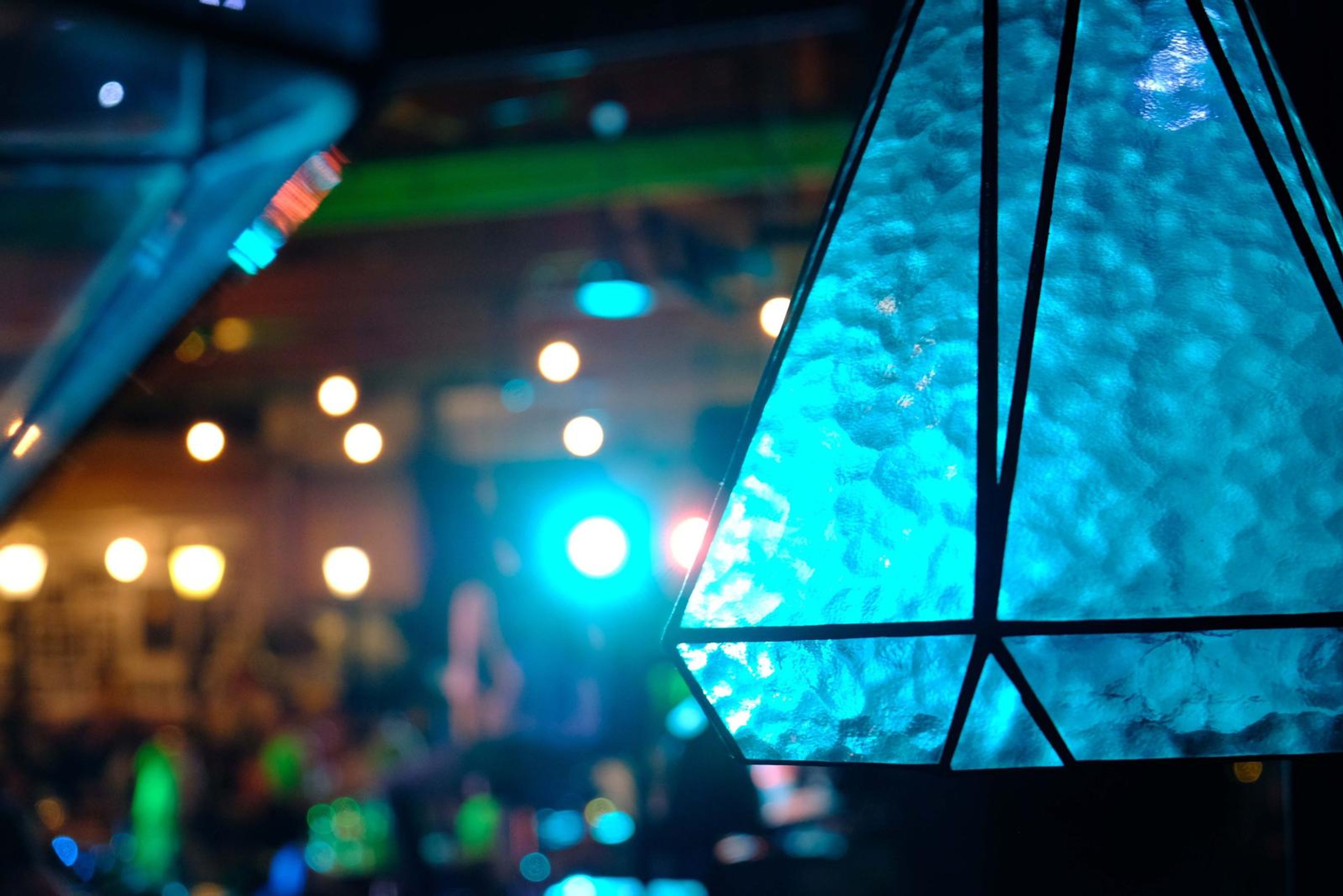 Blue stained-glass lantern with the stage lights behind it