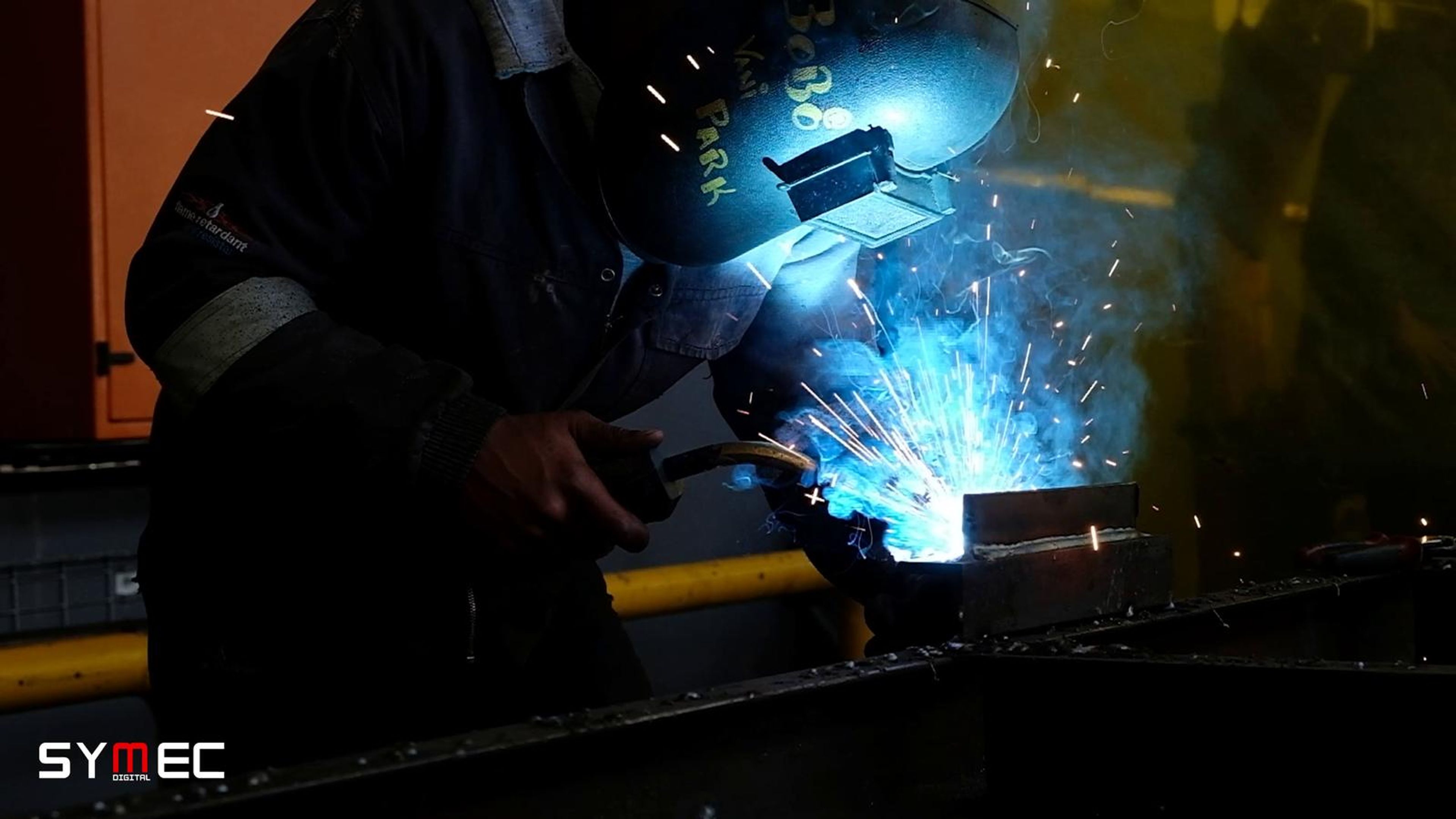 Welder in a mask with sparks