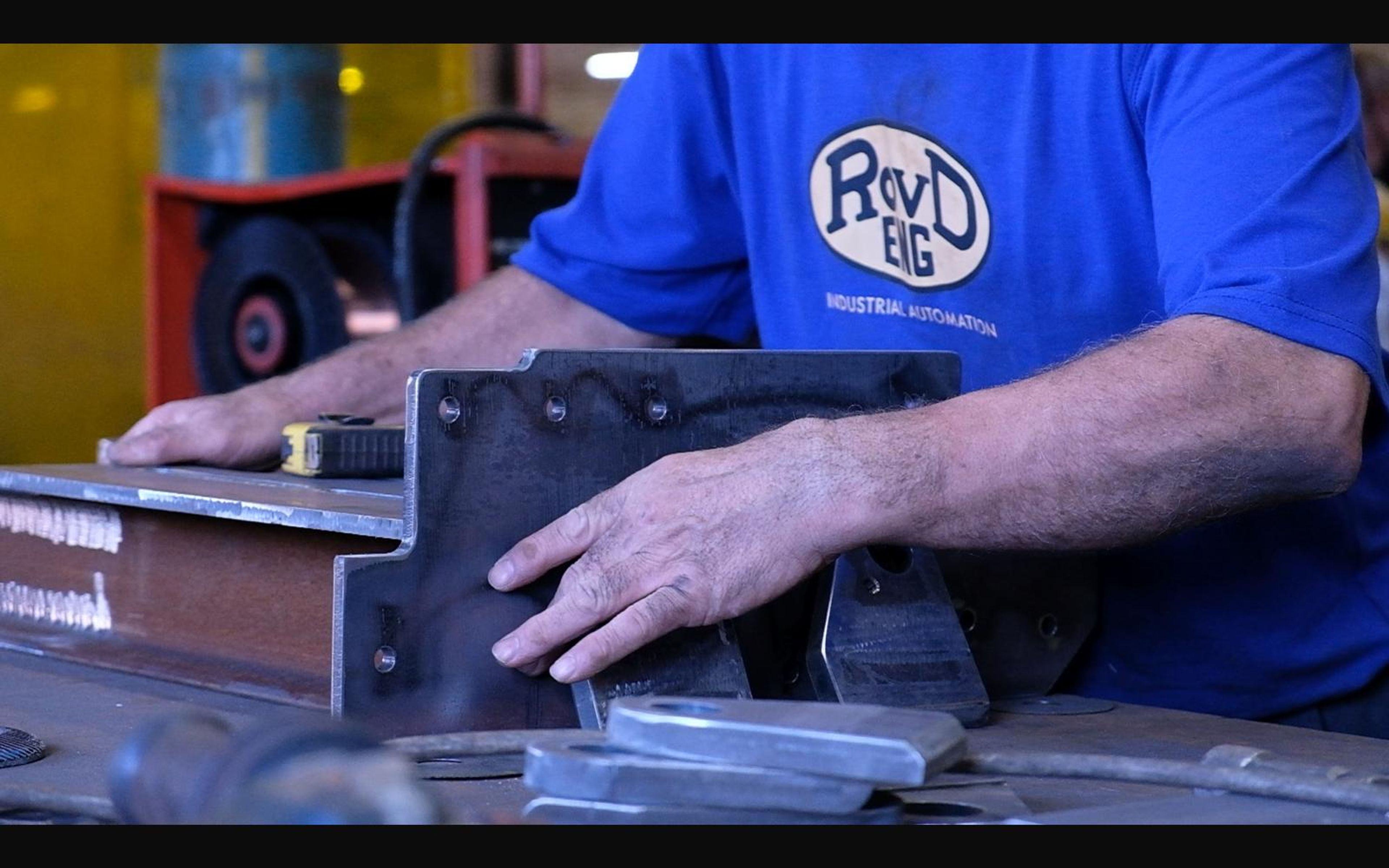 Fabricator checking a bolted steel bracket