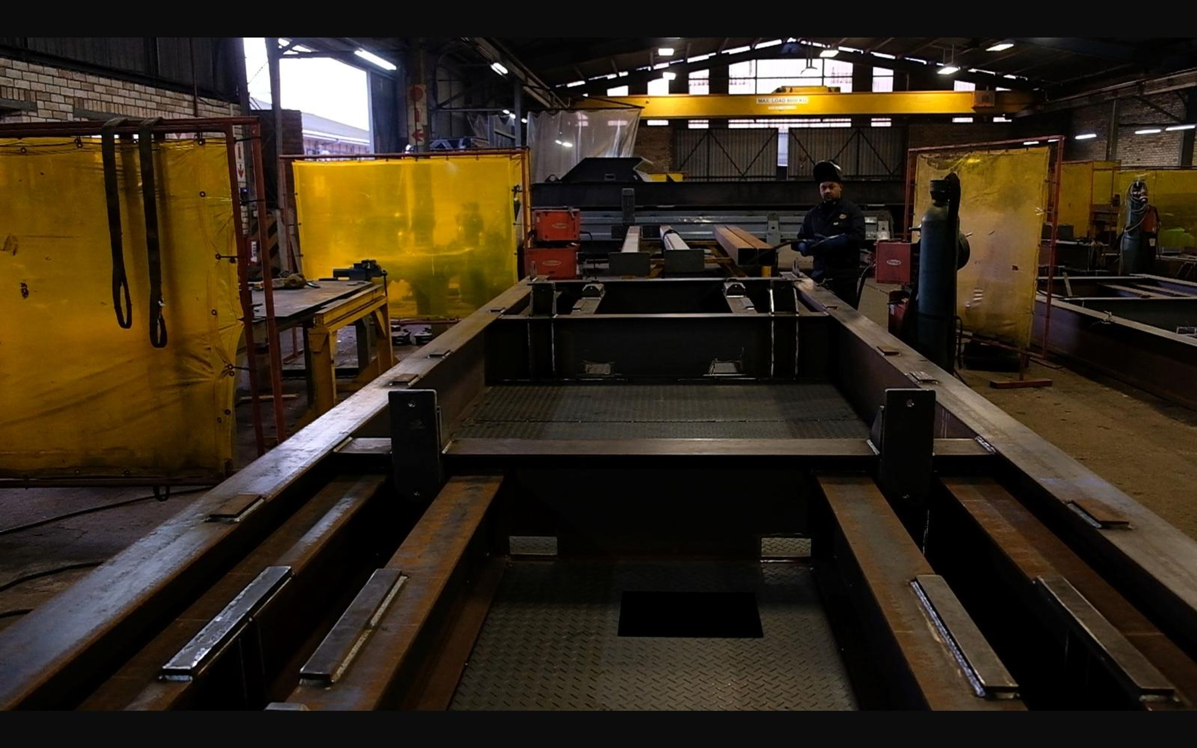 Large steel frame laid out on the fabrication floor