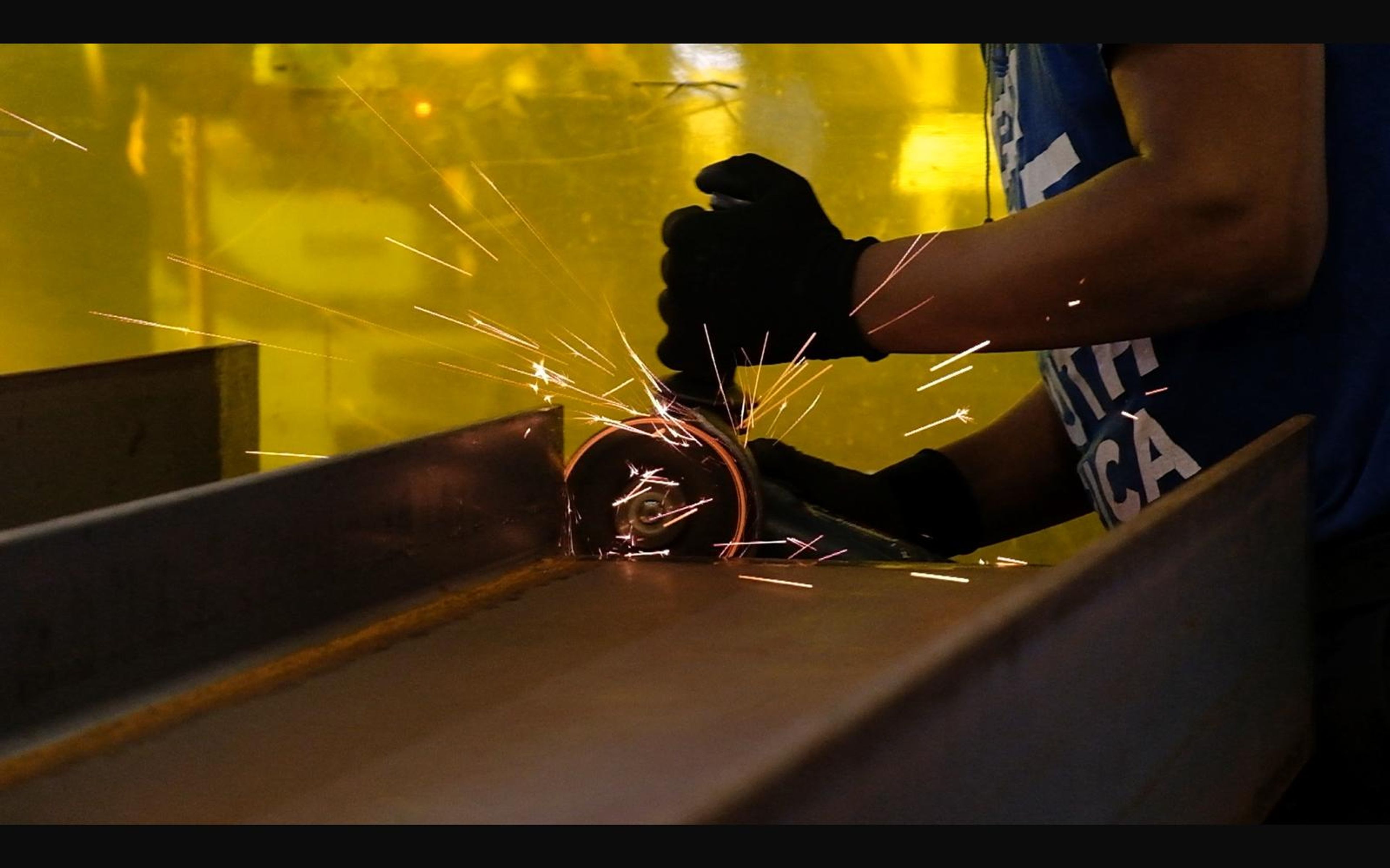 Grinding sparks beside a steel section