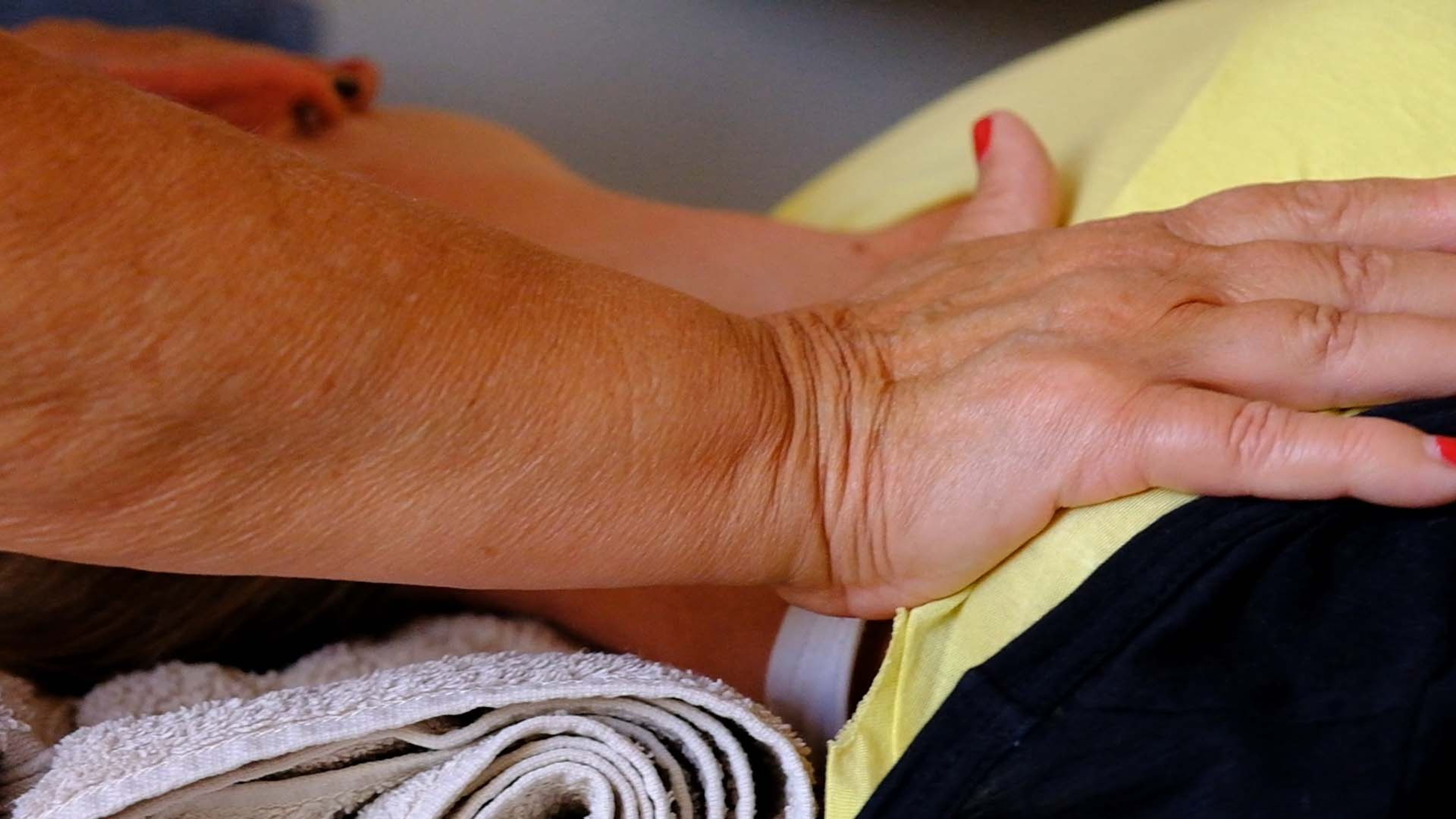 Close-up of hands on a client's back during a massage