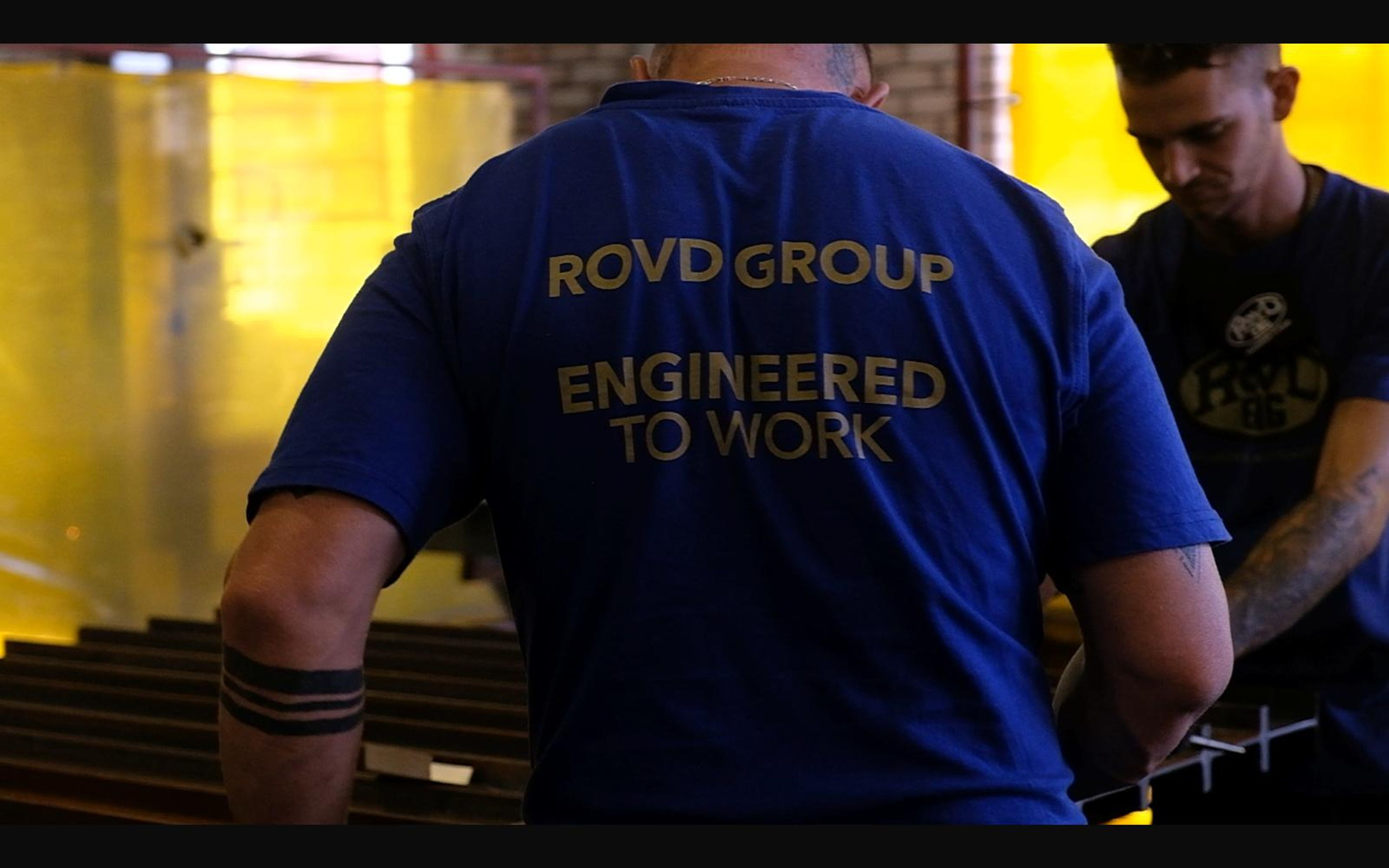 Fabricators in ROVD shirts at a steel frame