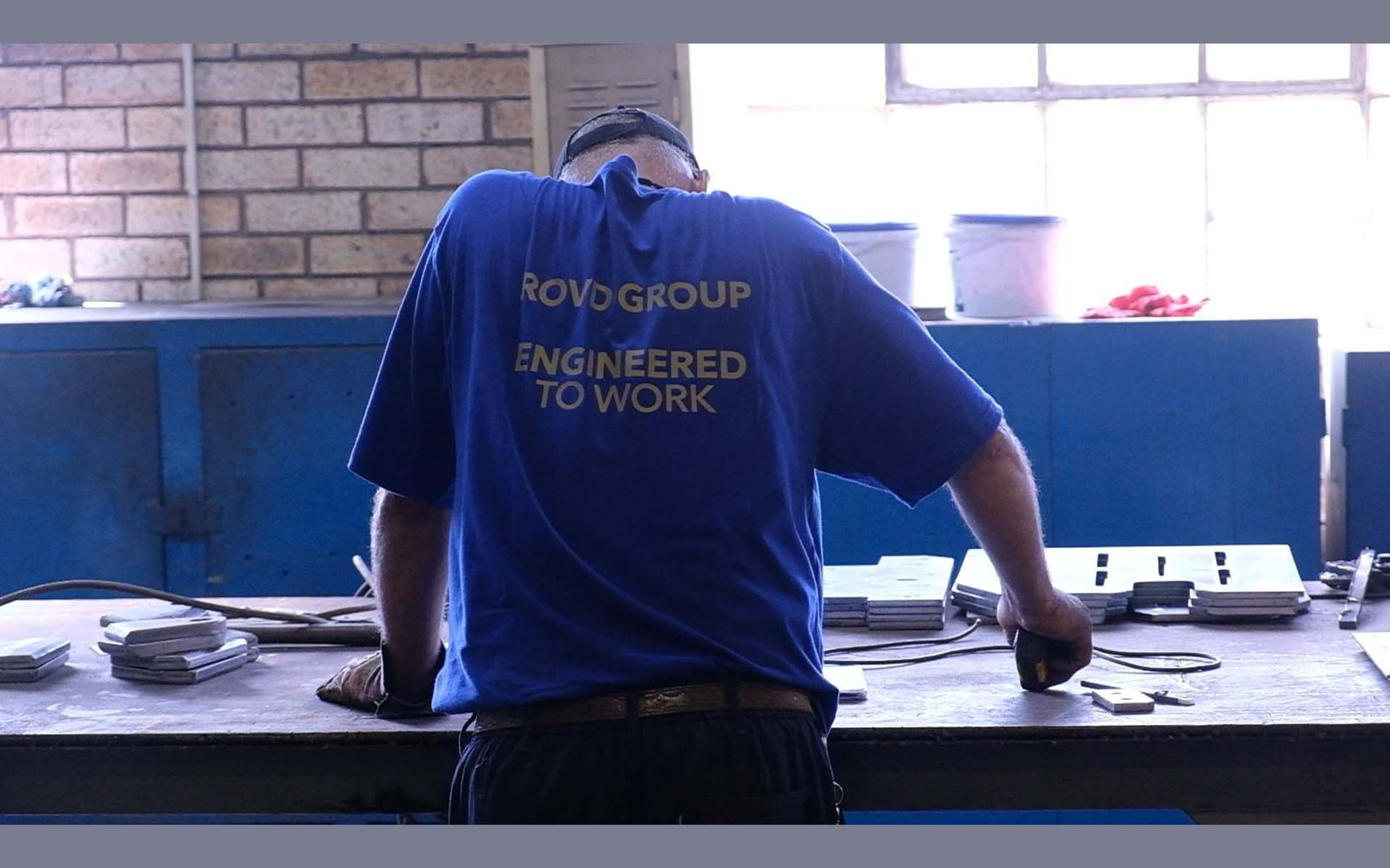 Hands working on a steel part in the fabrication sector