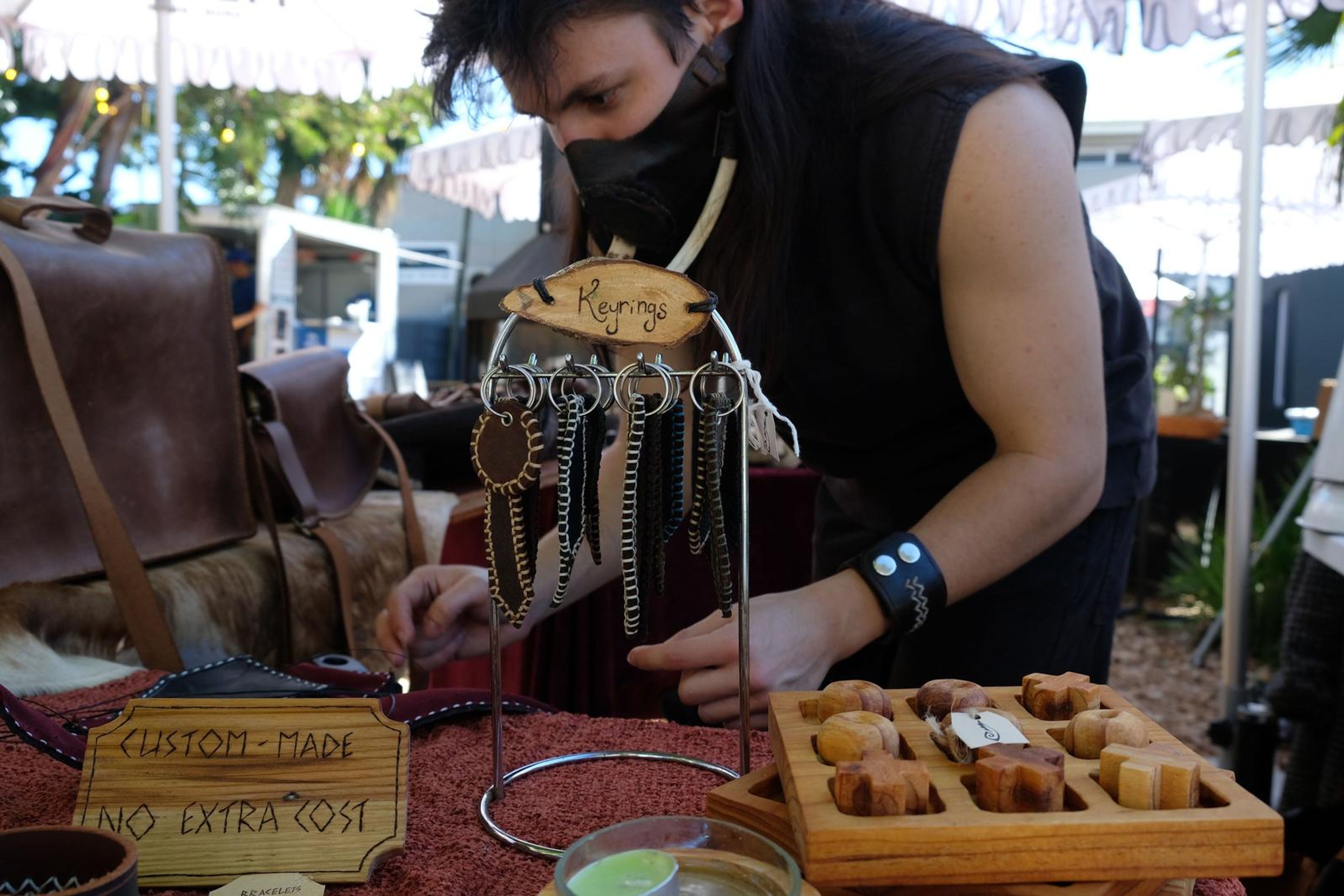 Juuks maker arranging leather goods and keyrings at the stall