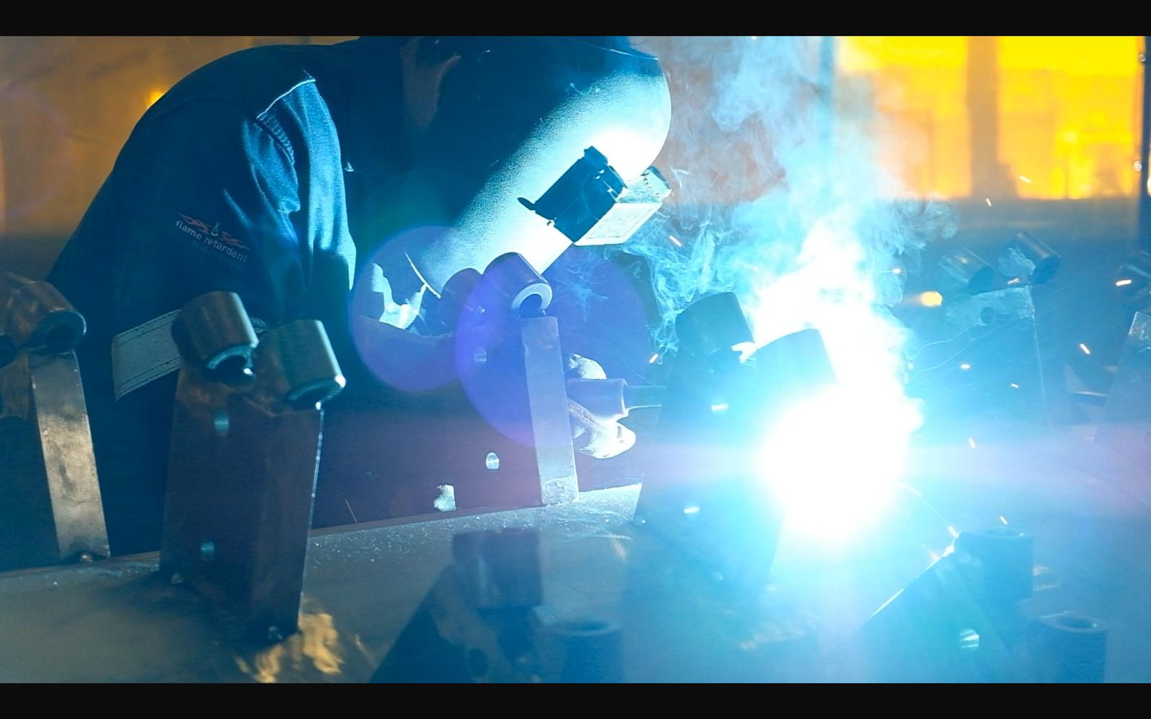 Welder with a bright flare on a fixture