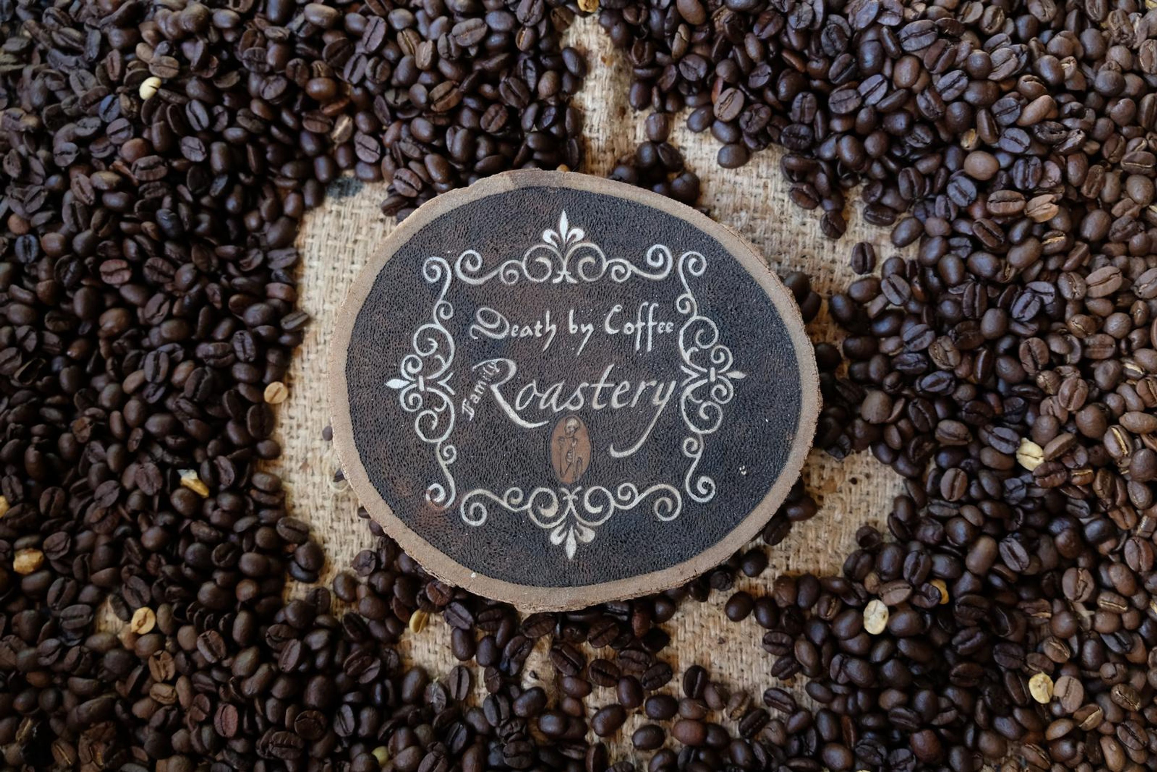 Death By Coffee creative product photography of coffee, beans and branded bags