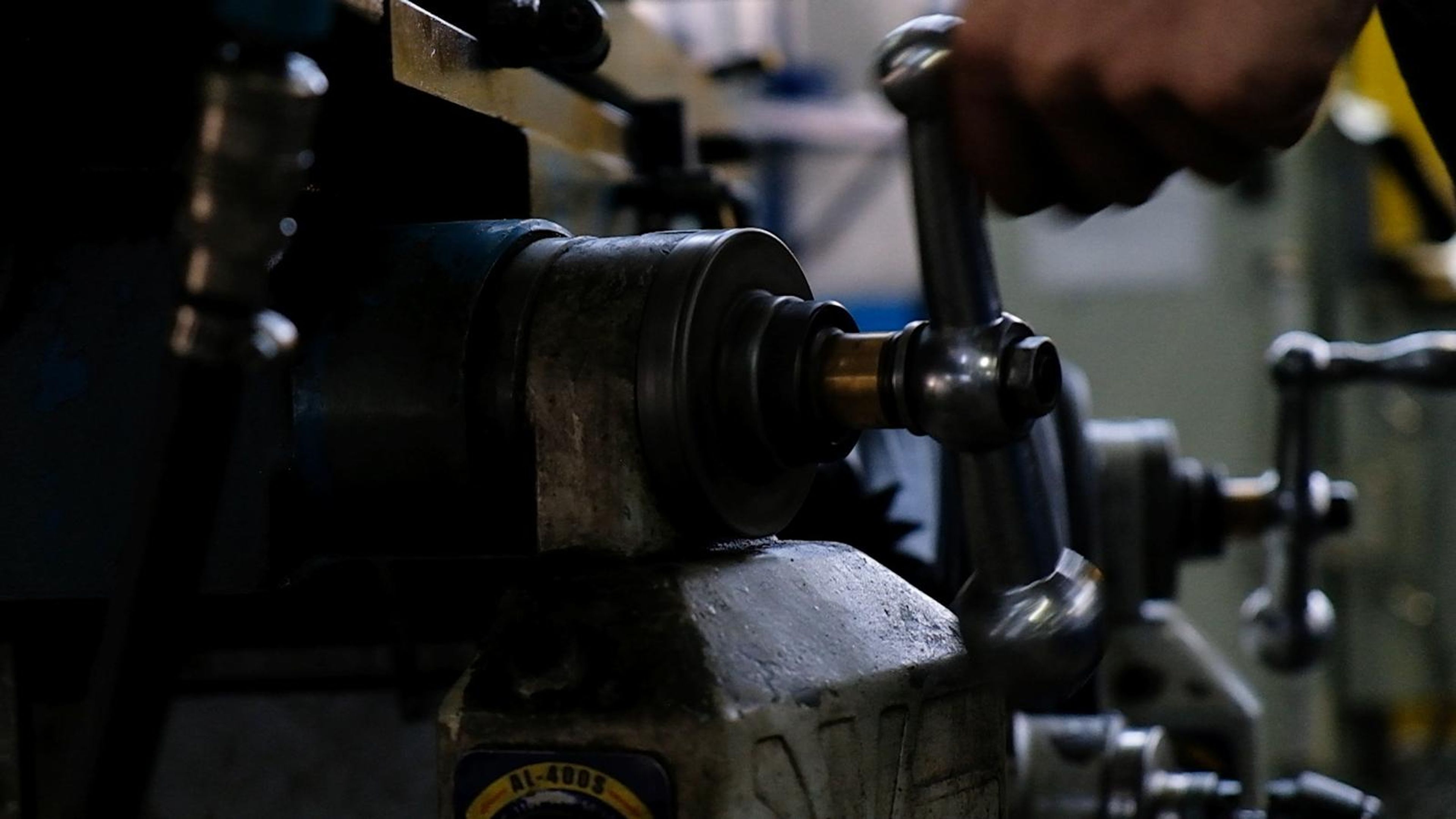 Hand working the lever of a drilling machine