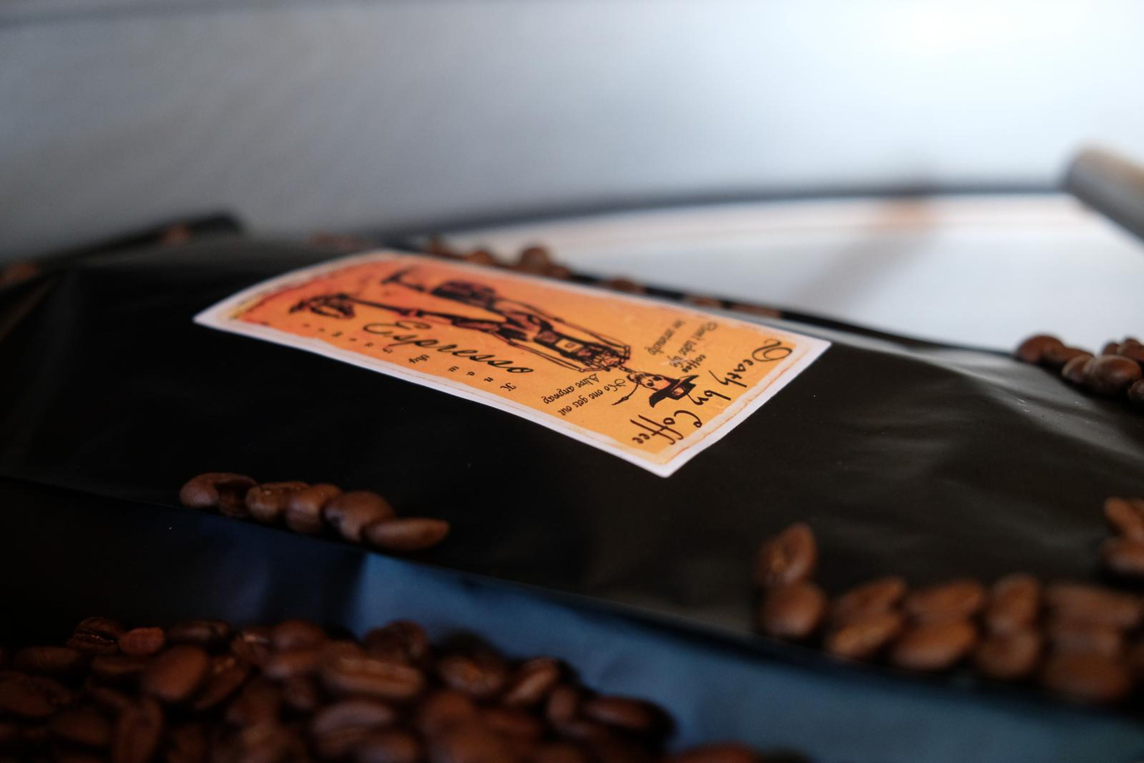 Death By Coffee creative product photography of coffee, beans and branded bags