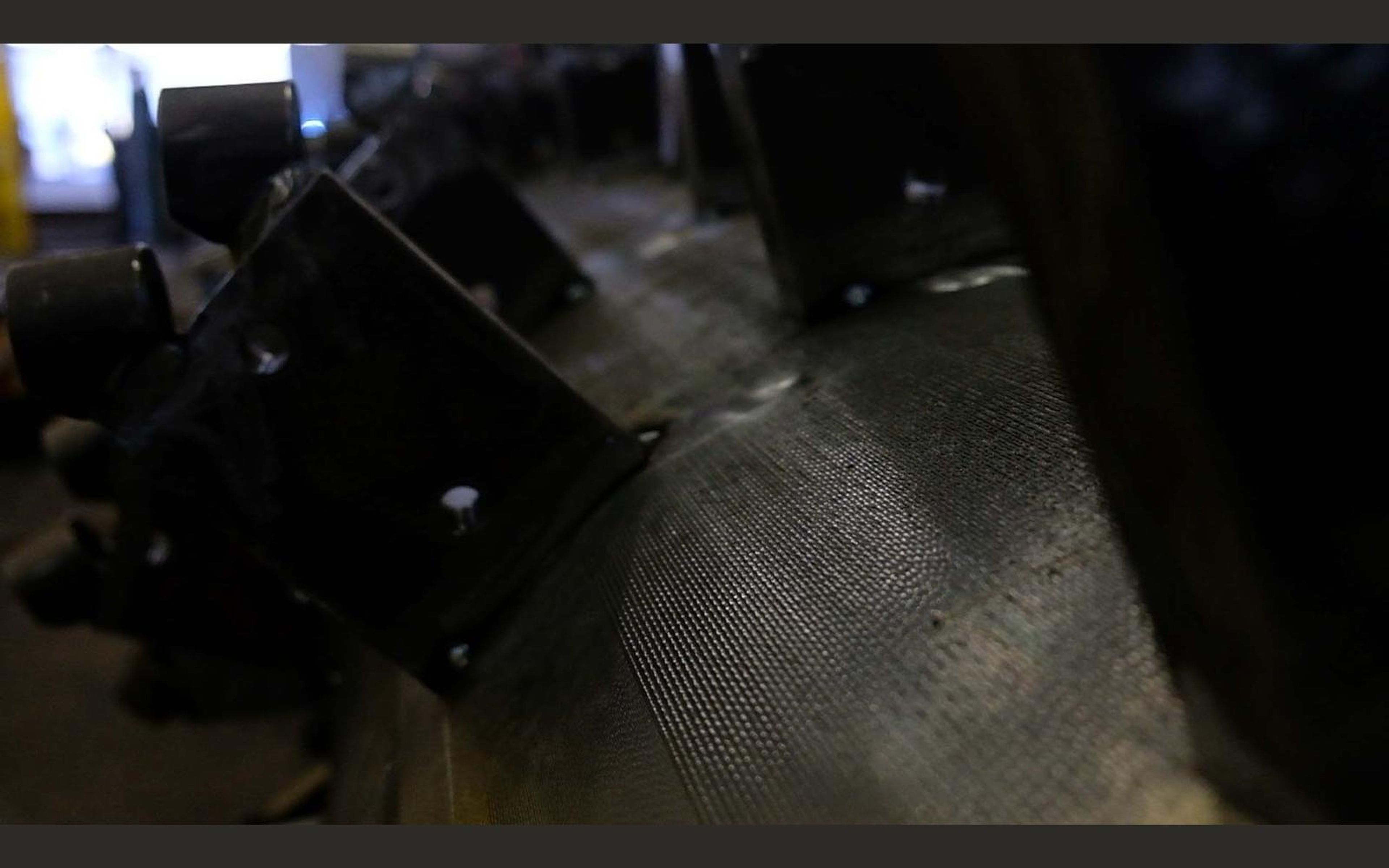 Steel mounting brackets in a yellow lit bay