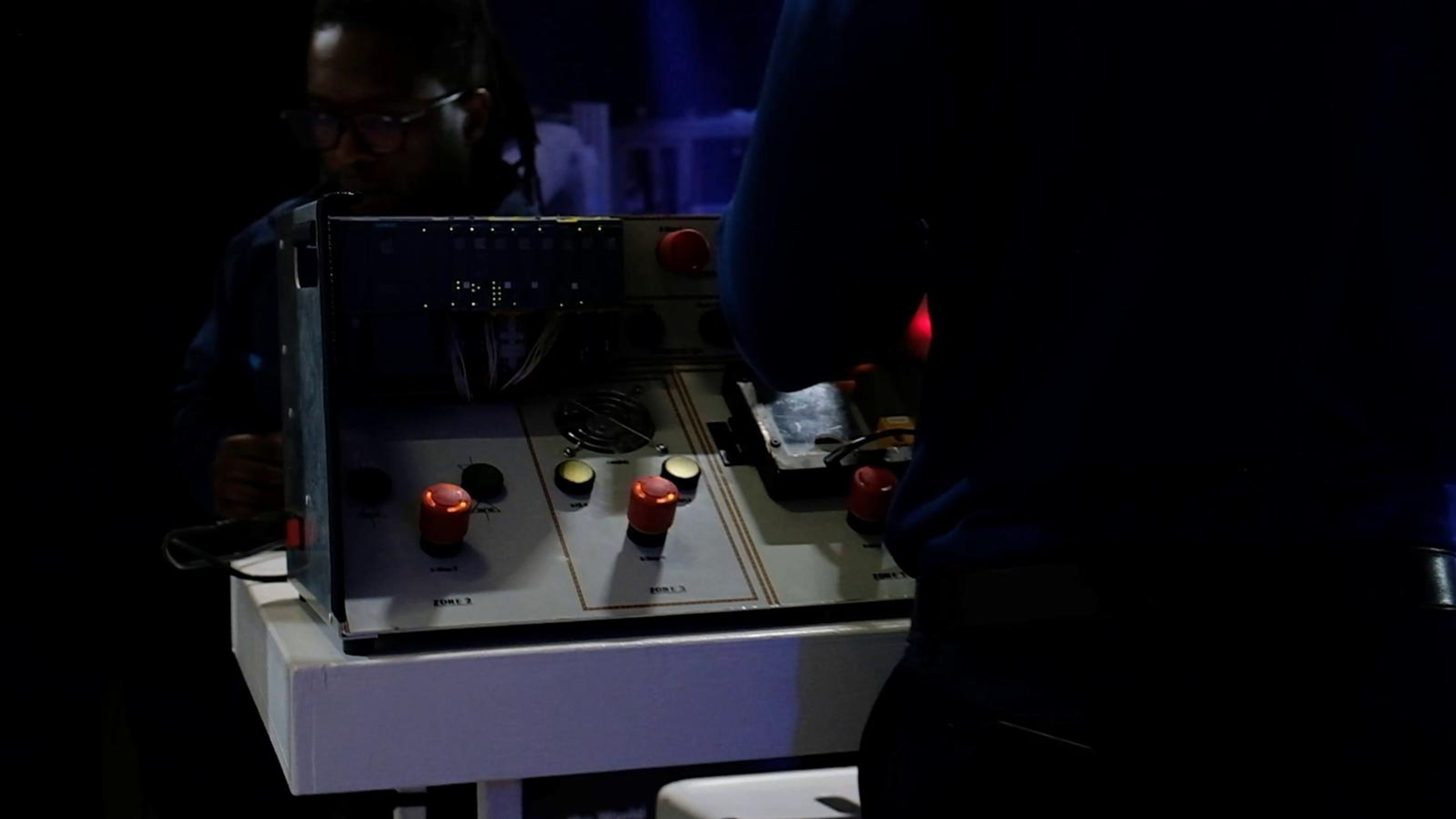 Visitor operating a control panel on an automation demonstration