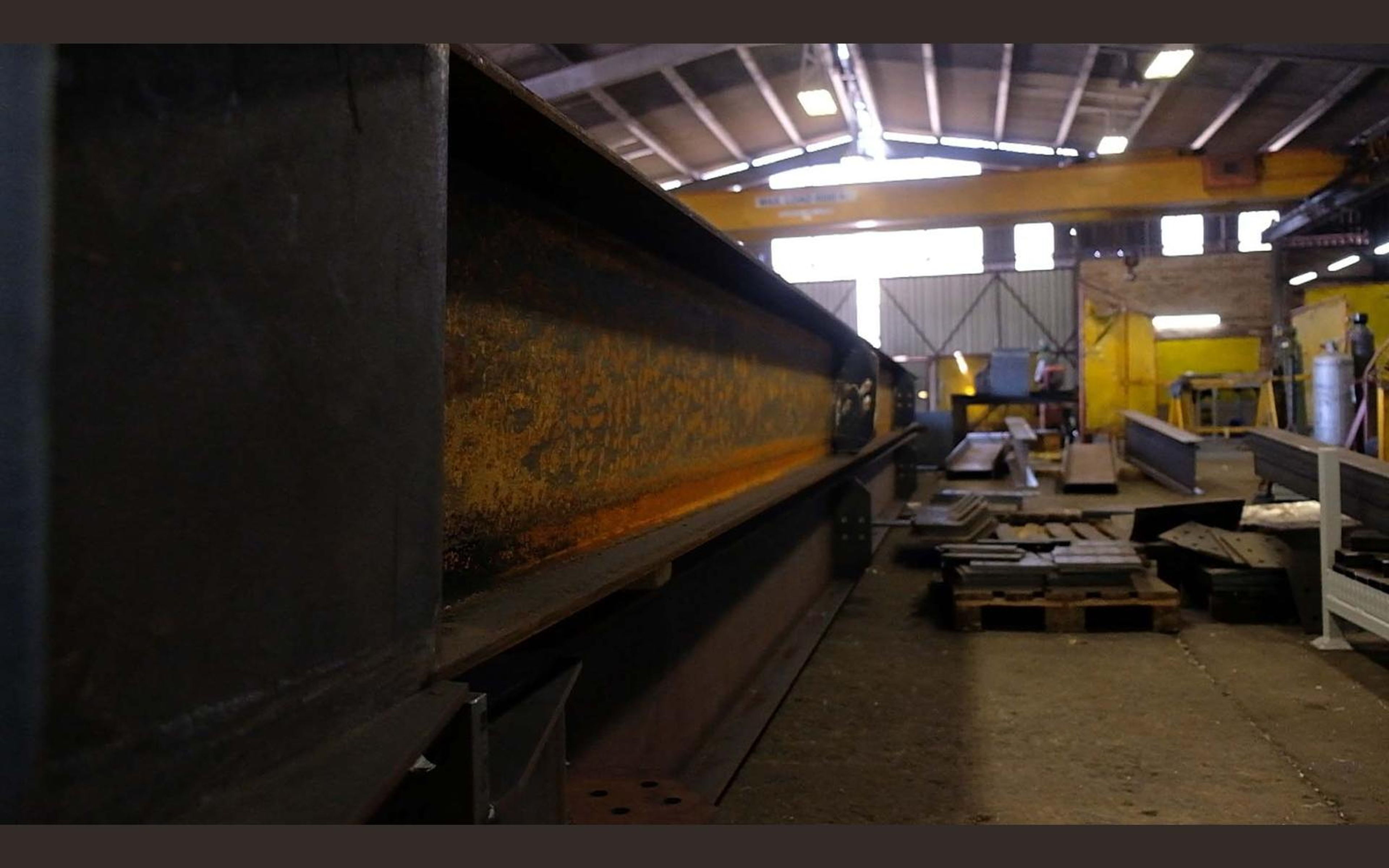Wide view of the fabrication sector with steel frames on the floor