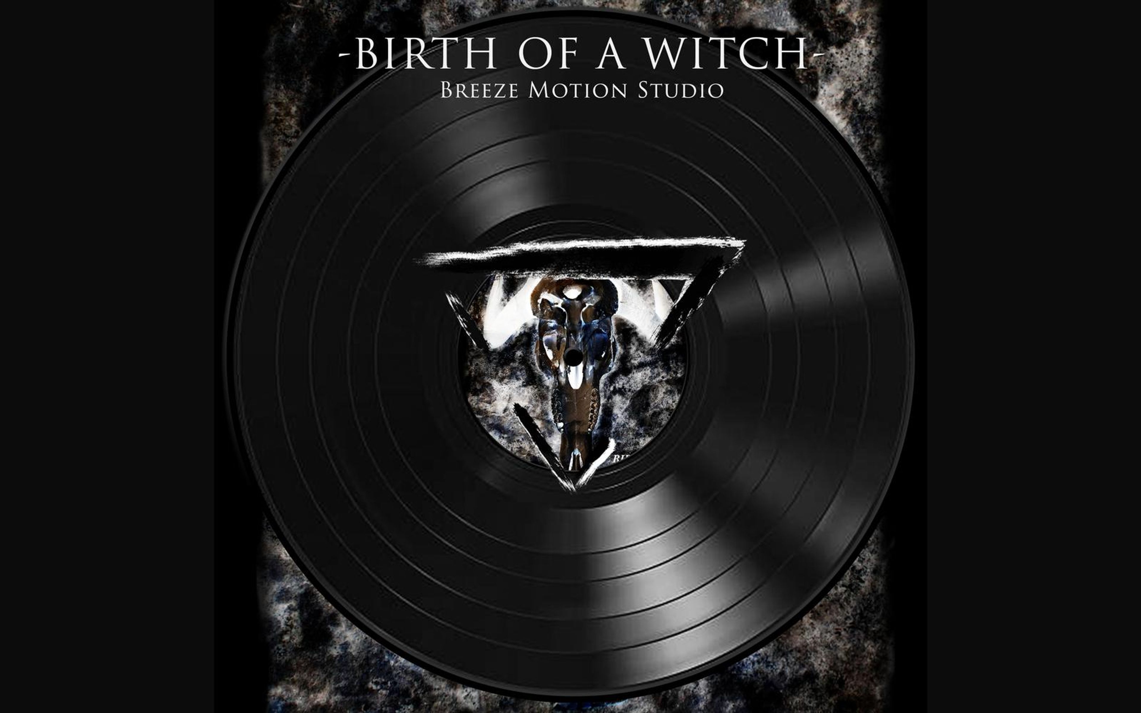 Black vinyl record graphic with a triangular cut-out showing the skull artwork, titled Birth Of A Witch