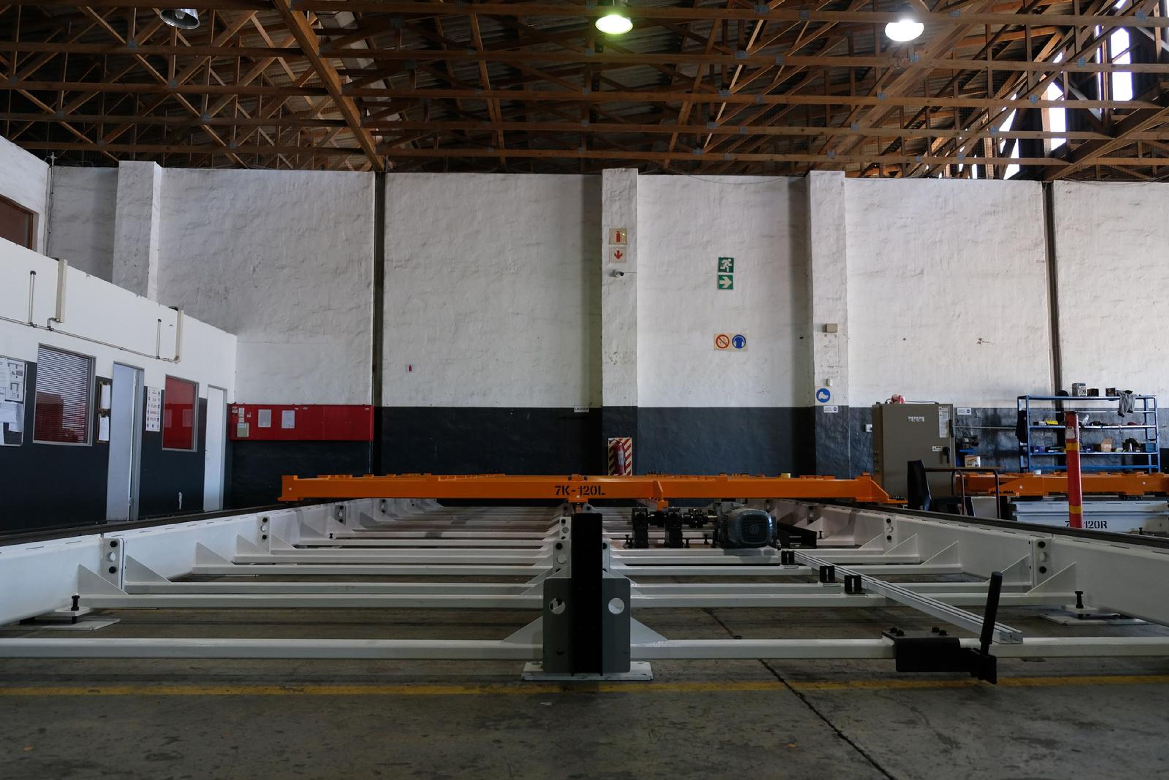 Wide low view of the orange tool with its central rail running away