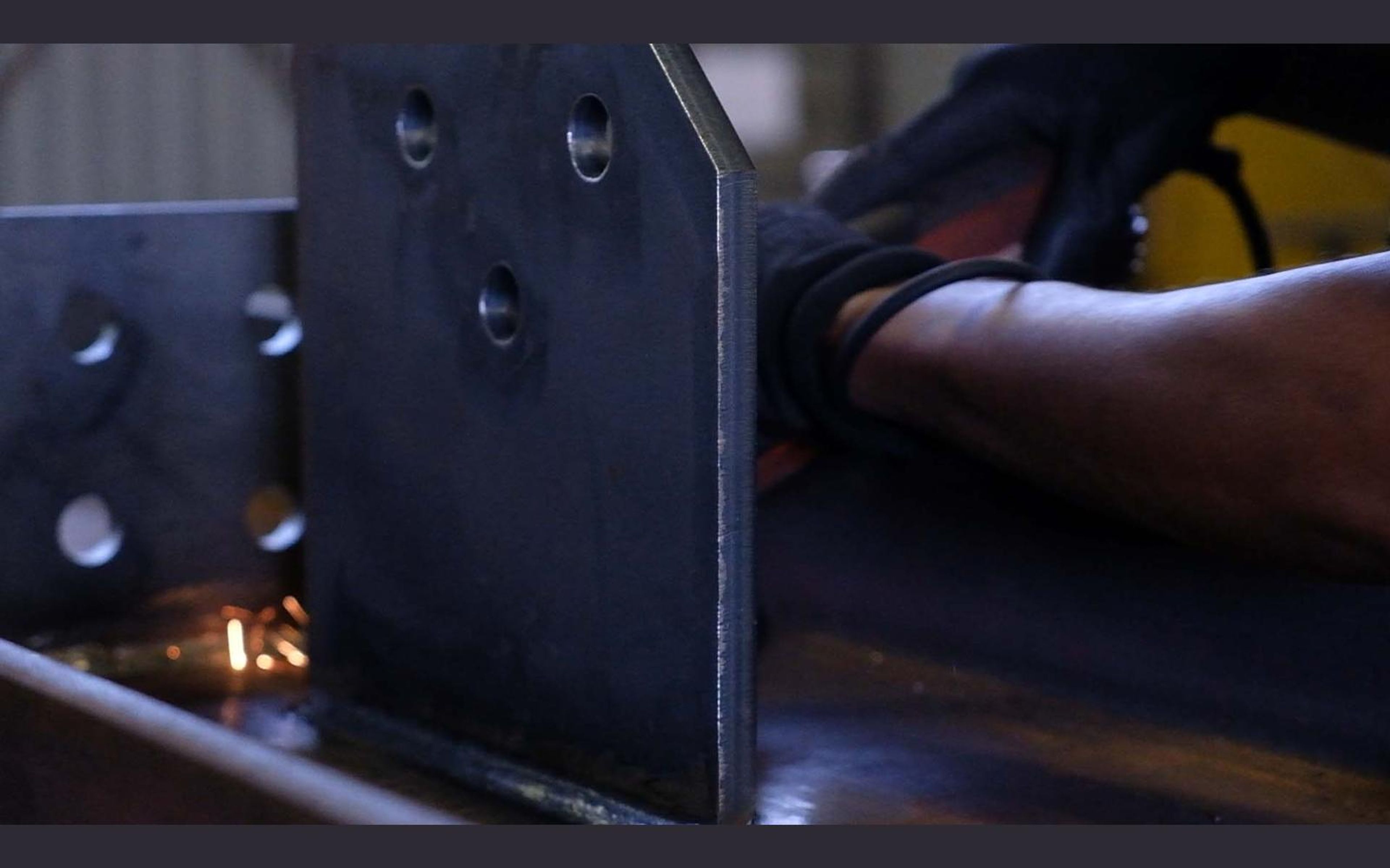Team members working on a steel assembly