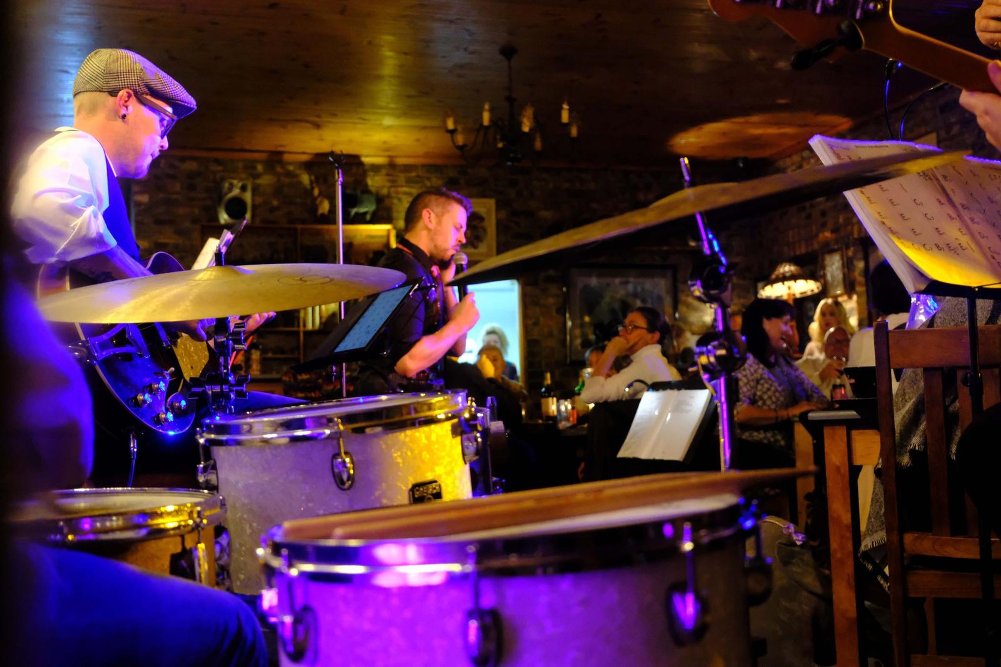 Wide view of the drummer and band at the back of the room