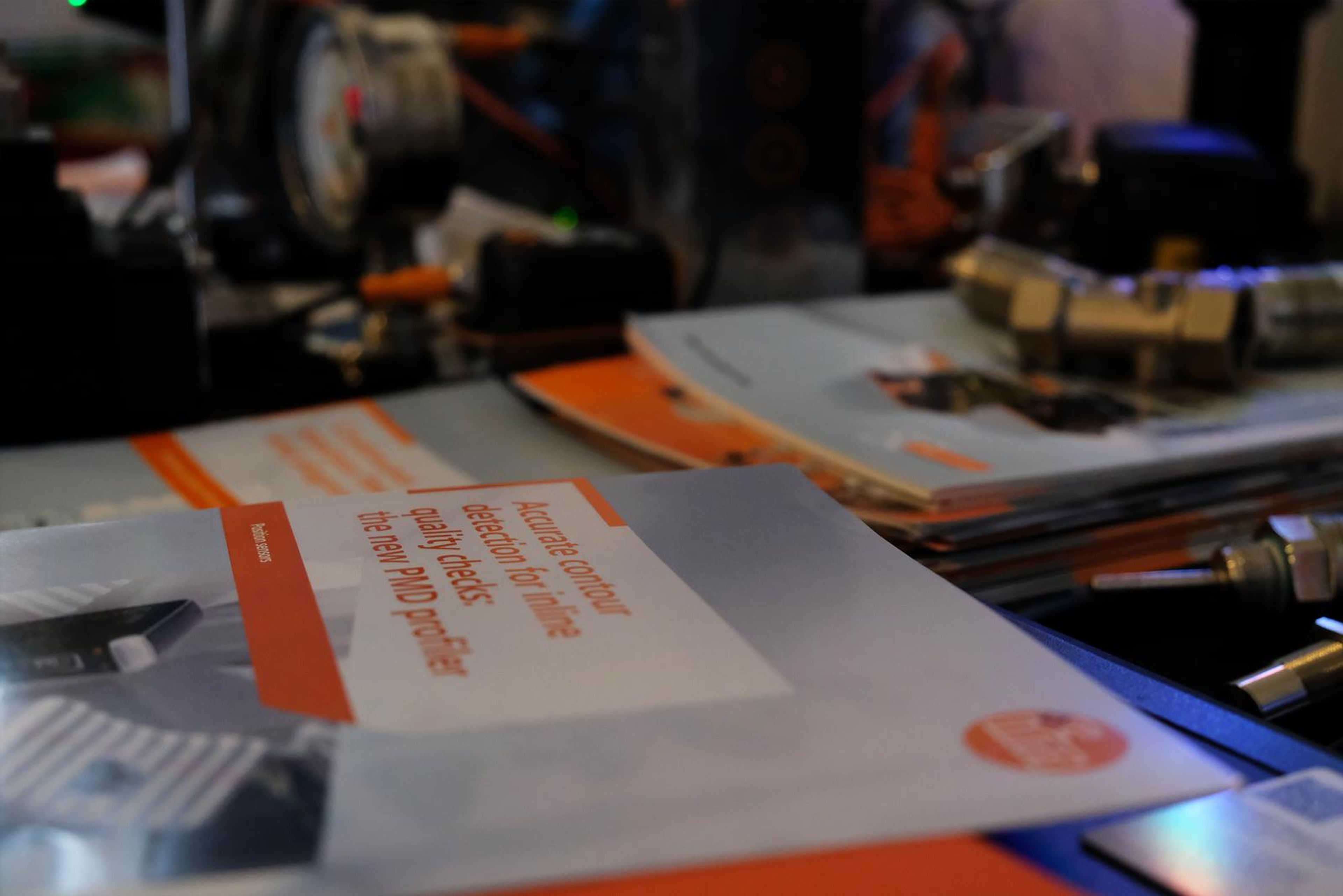 IFM sensors and product brochures on a display table