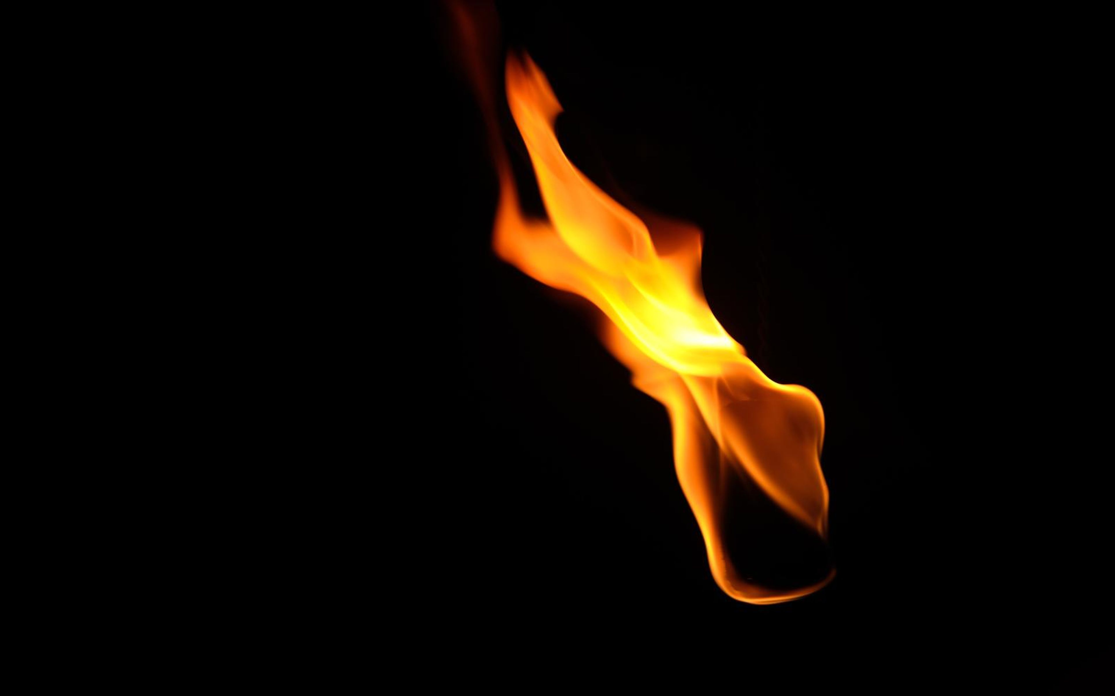 Flame sweeping diagonally up to the left with a thin wisp above