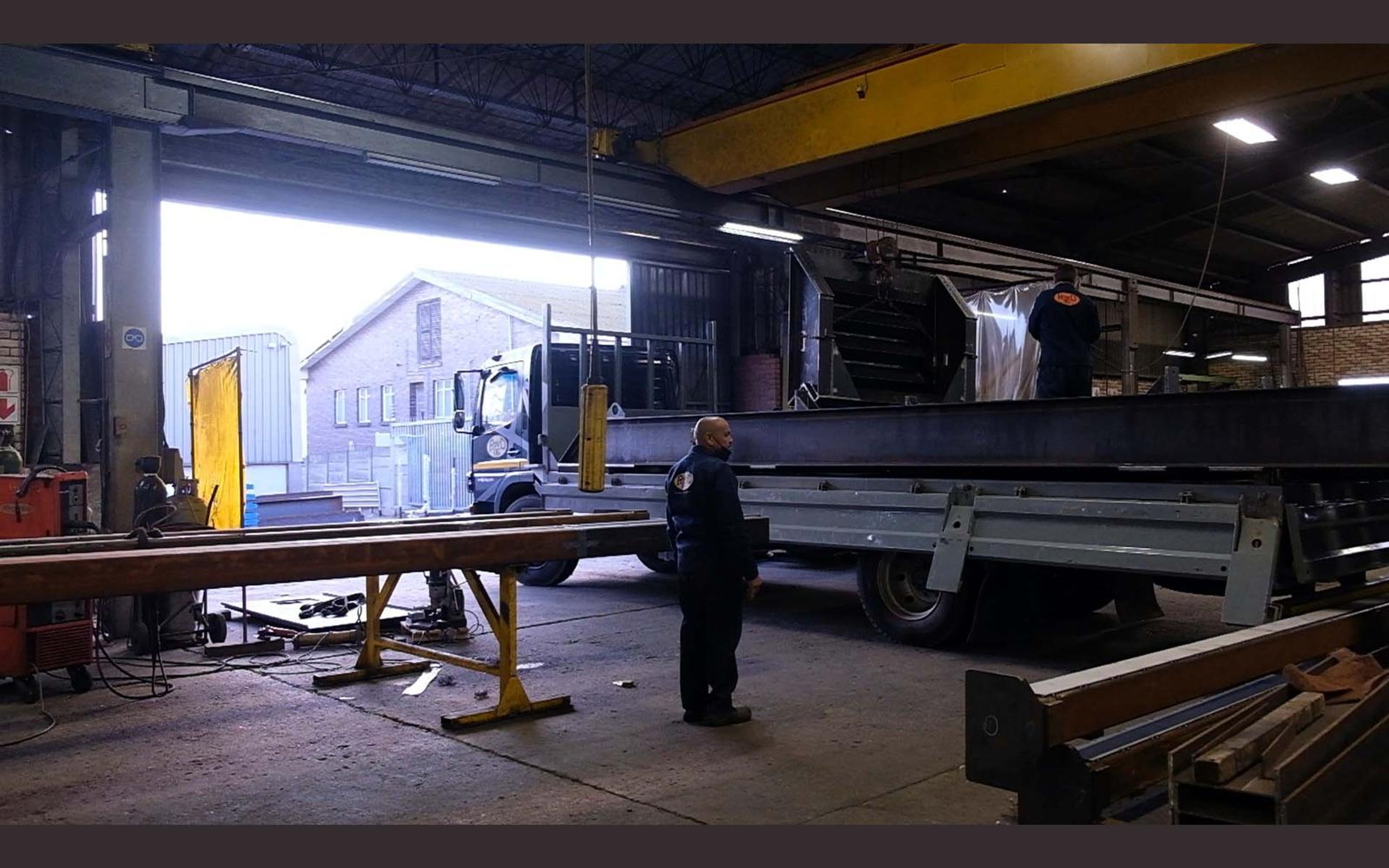 Steel frames laid out across the fabrication sector floor