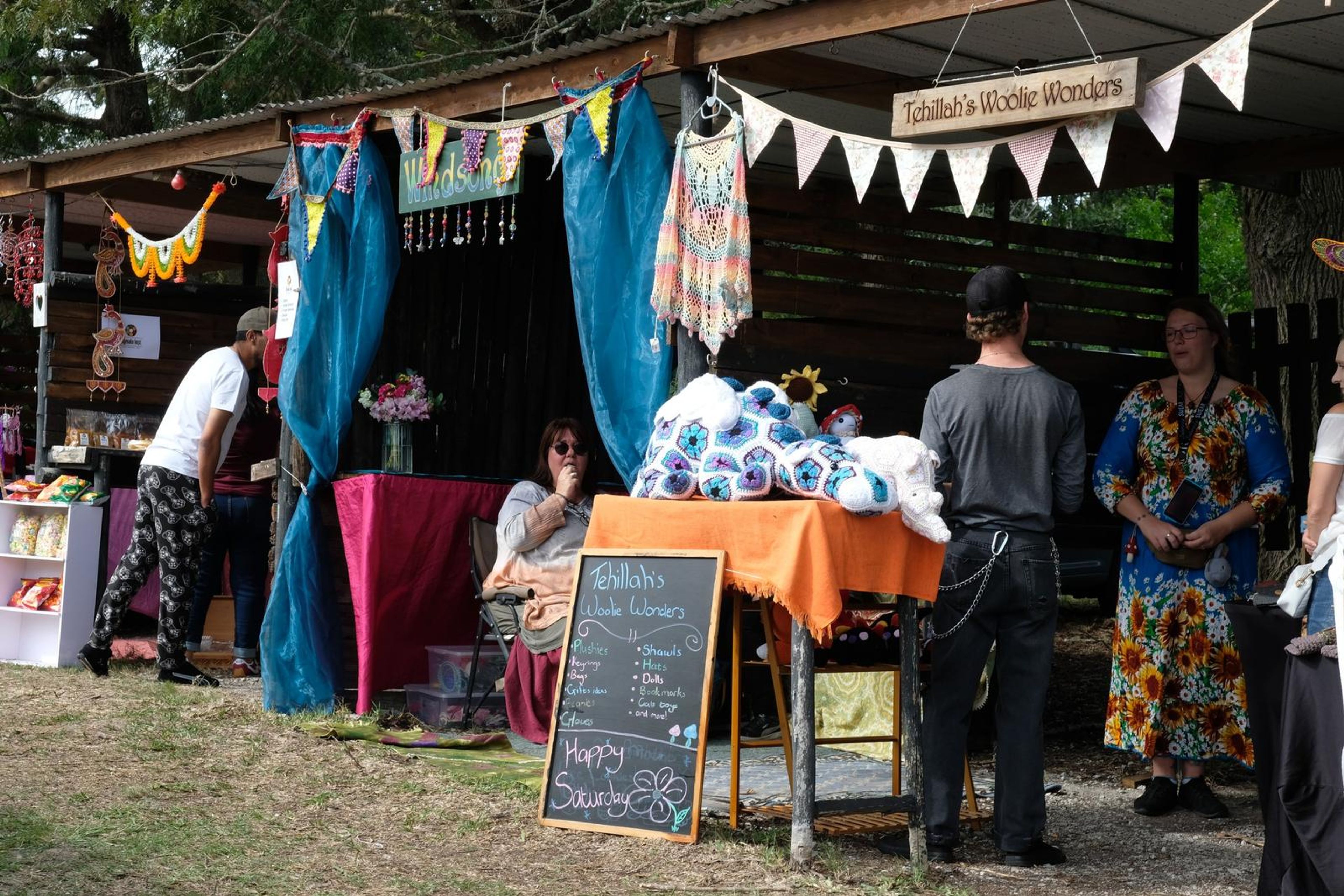 Crowd walking past stalls at Windsong Boho market