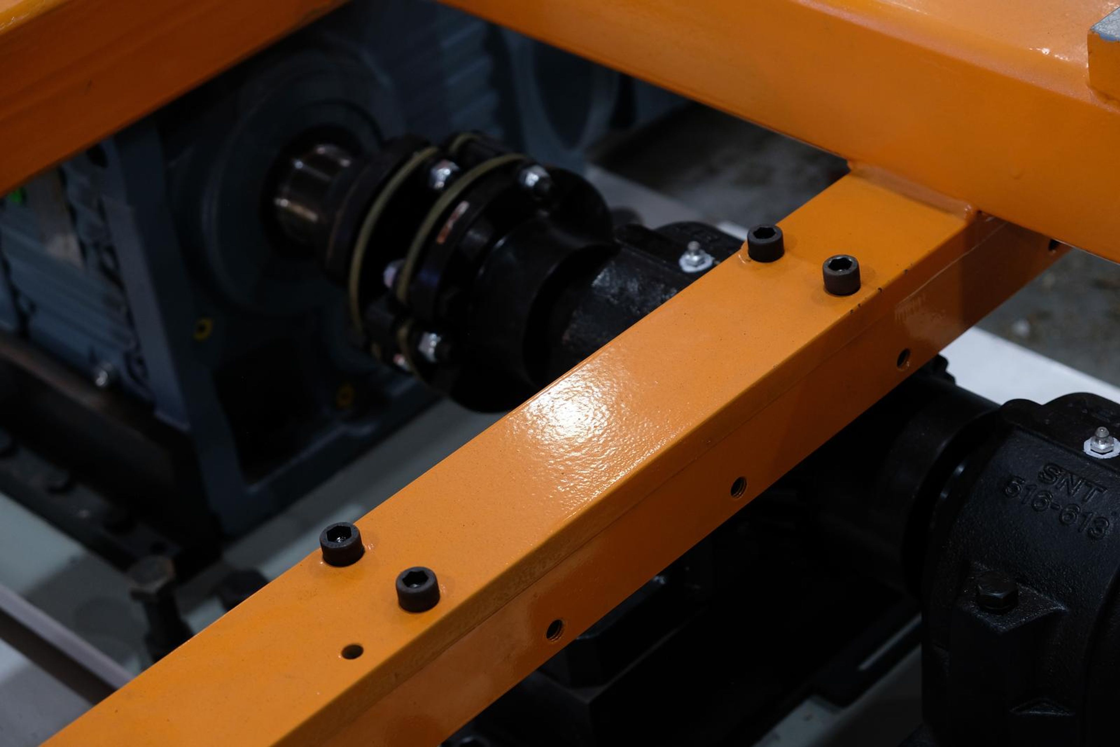 Gearbox and coupling under an orange frame member
