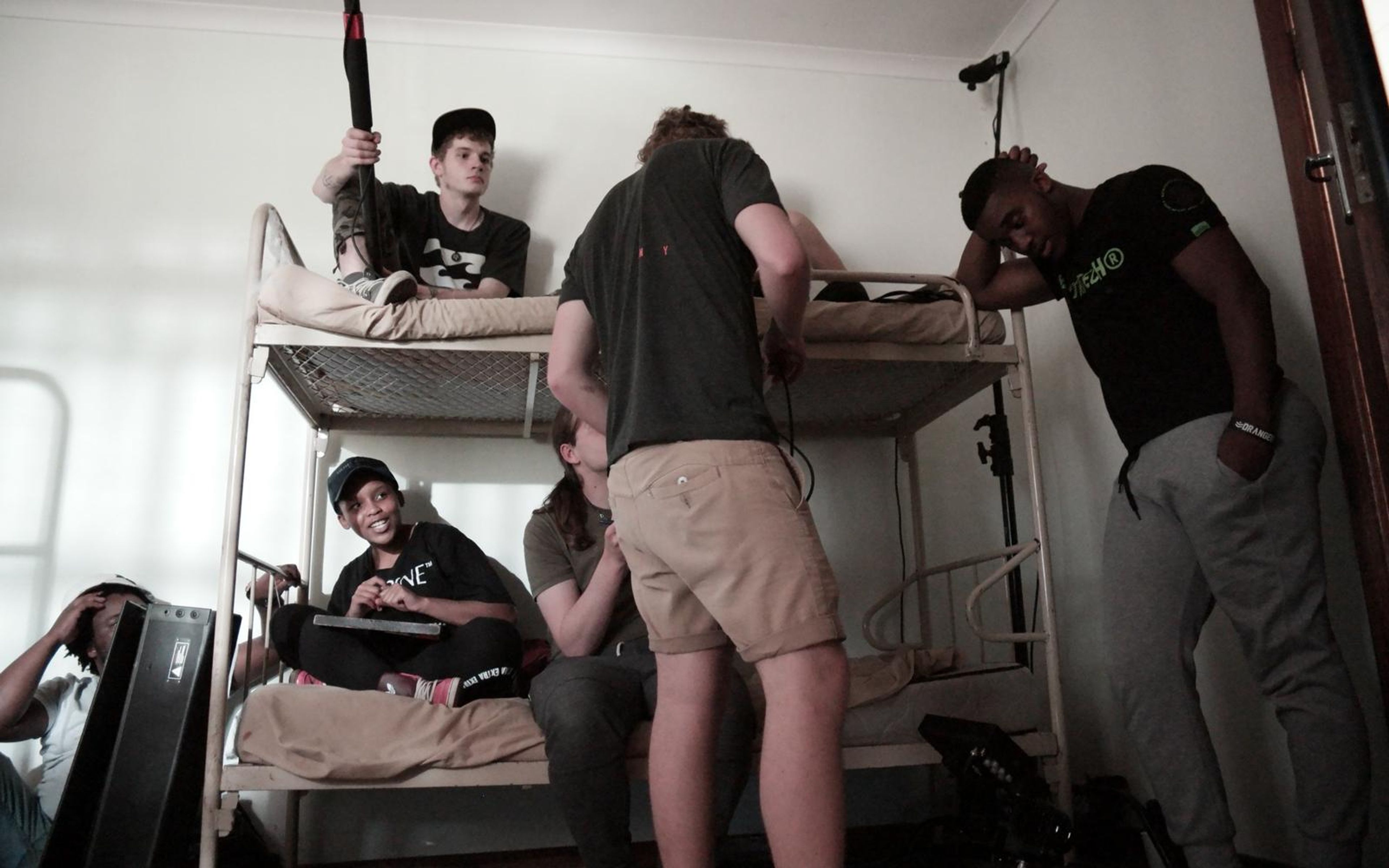 Crew in a bunk room with a boom pole held over the beds