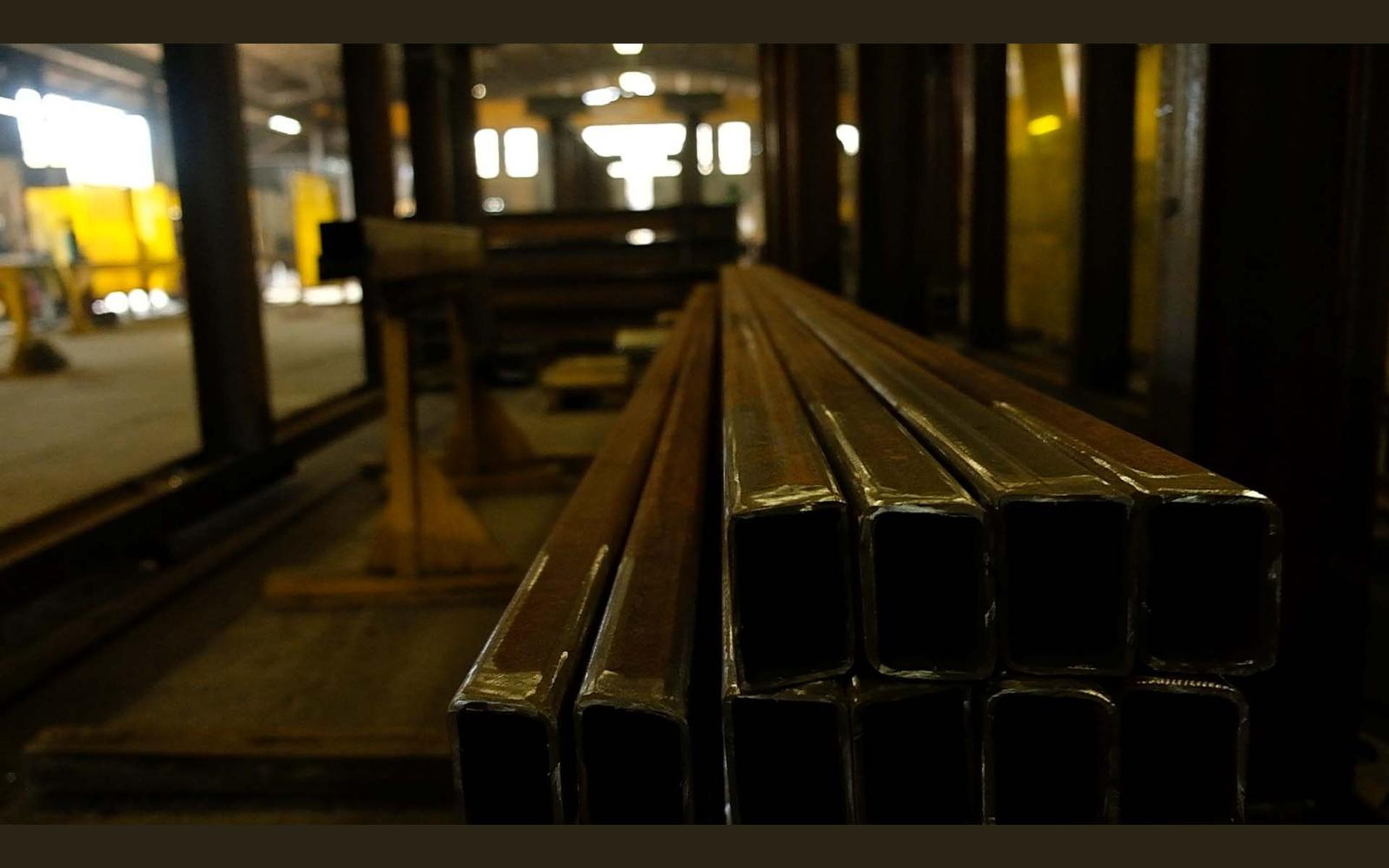 Long steel beam seen along its length on the shop floor