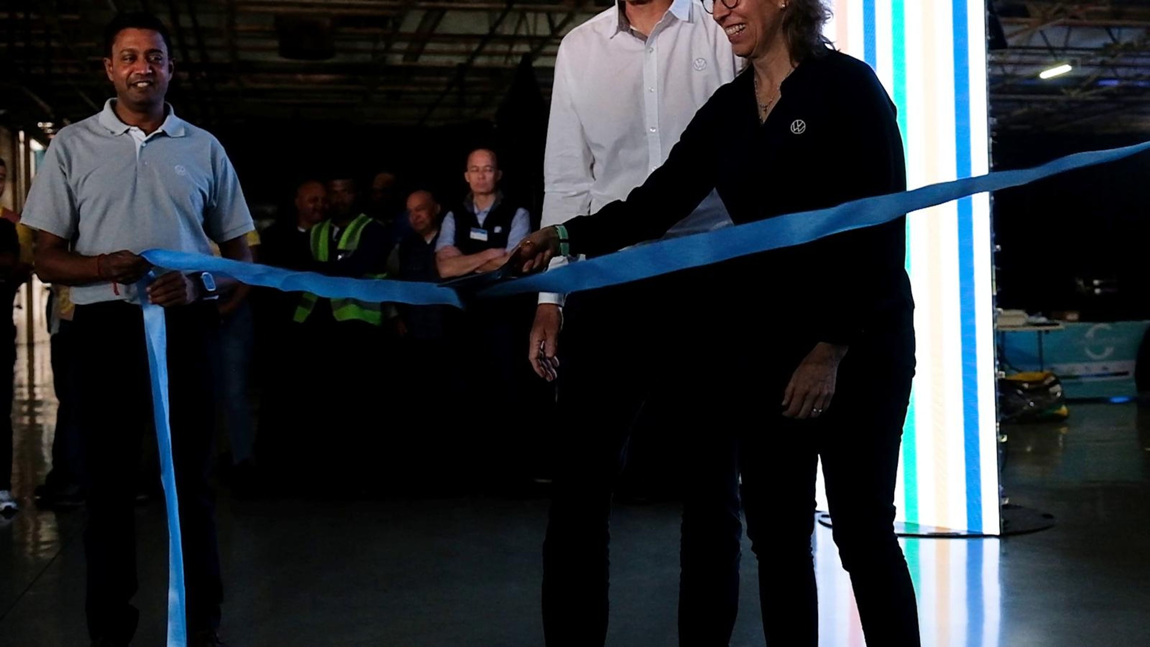 Hosts cutting the ribbon to open the expo