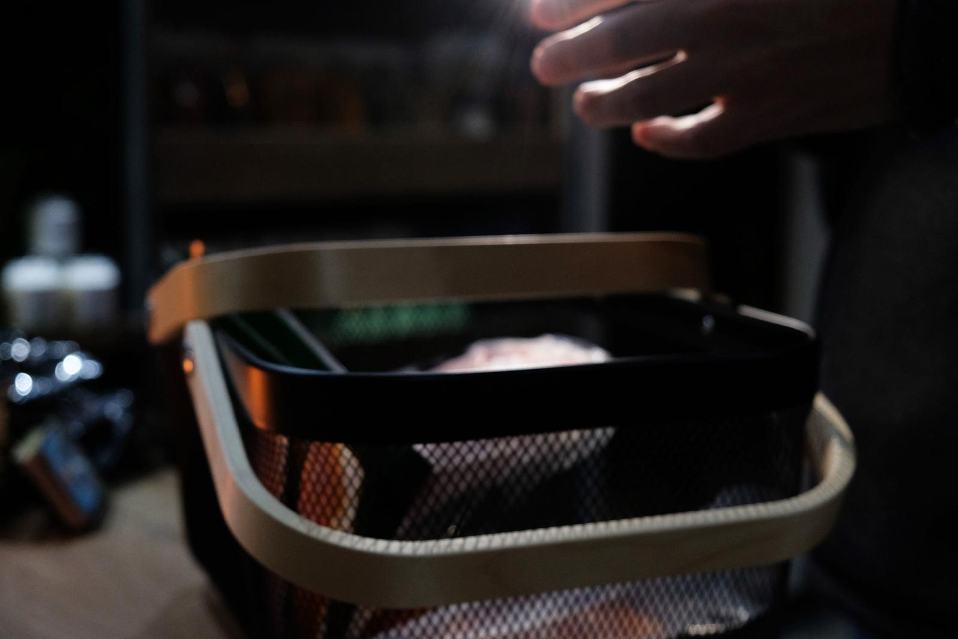 Black and wood shopping basket held at the counter