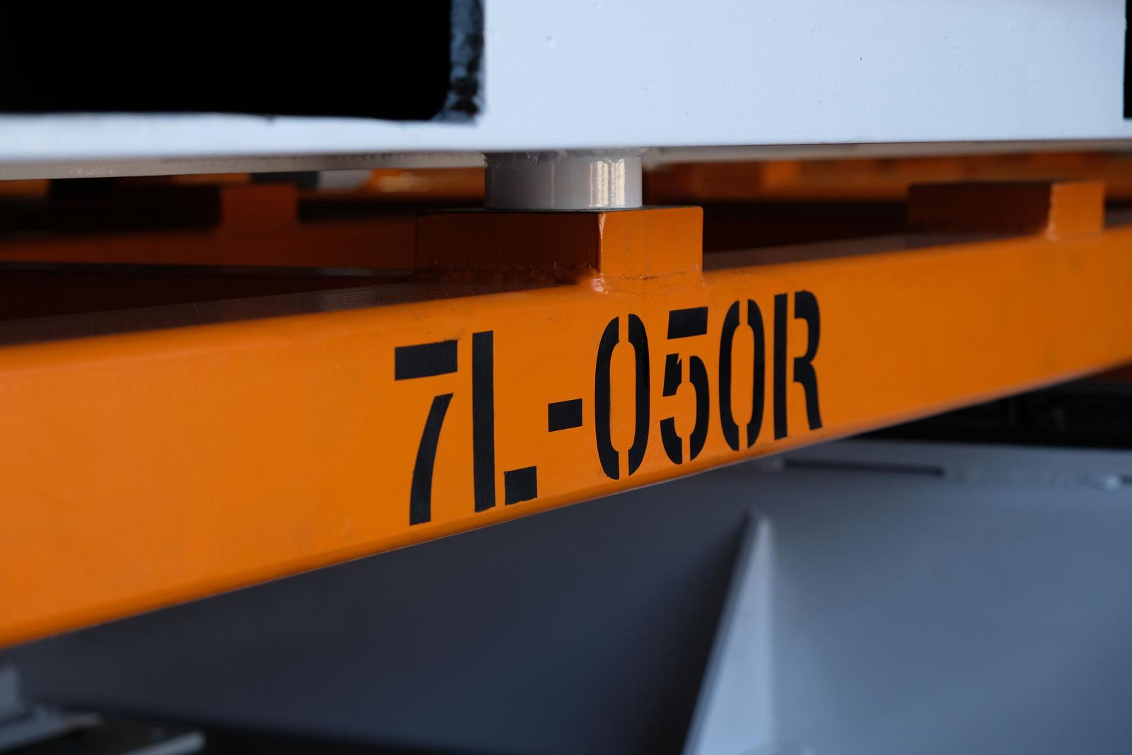Close view of 7L-050R stencilled on an orange beam
